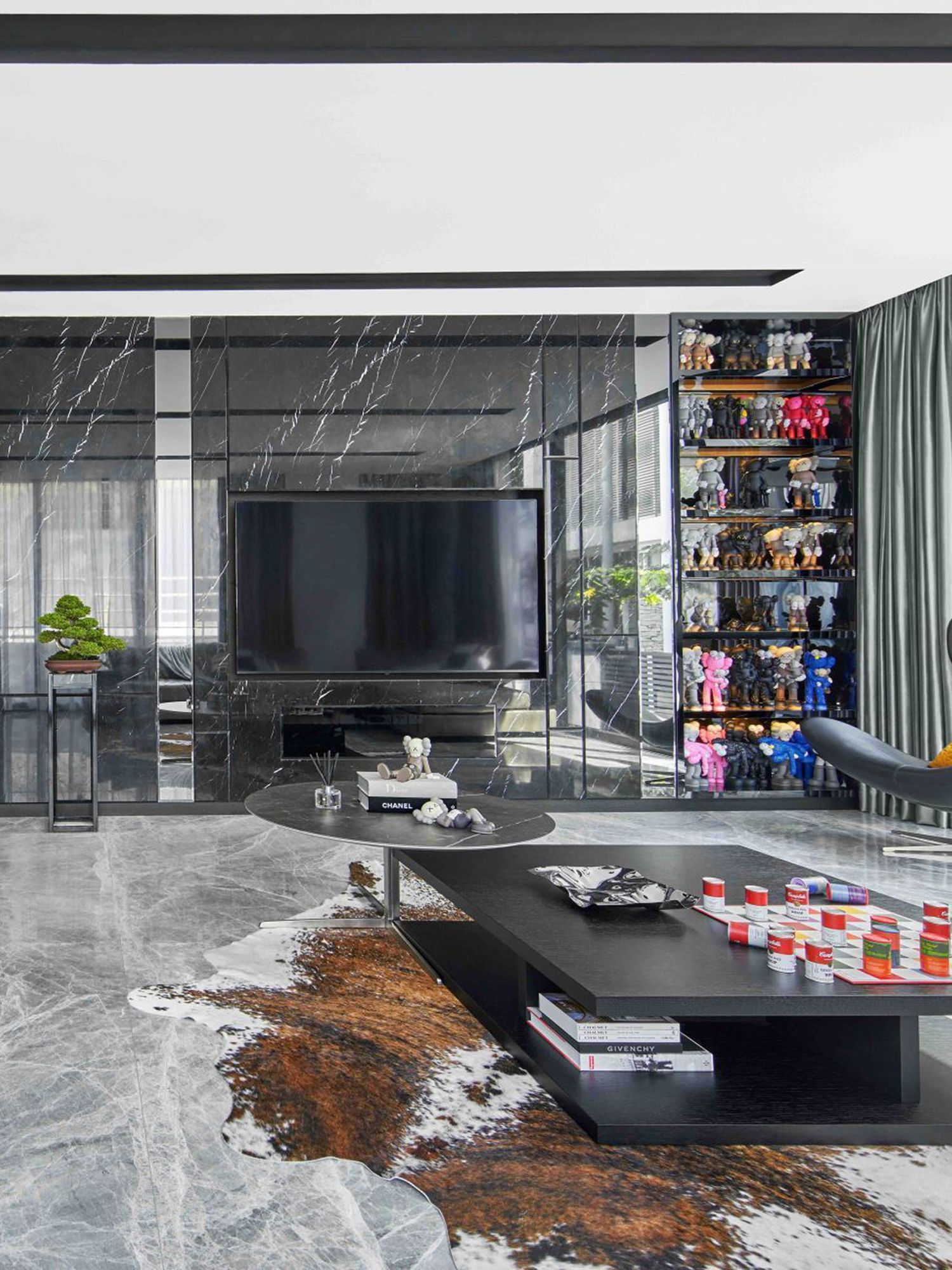 The Kaws figurines add a pop of colour in this stylish monochromatic living room created by Prestige Global Designs Photography: Jasper Yu