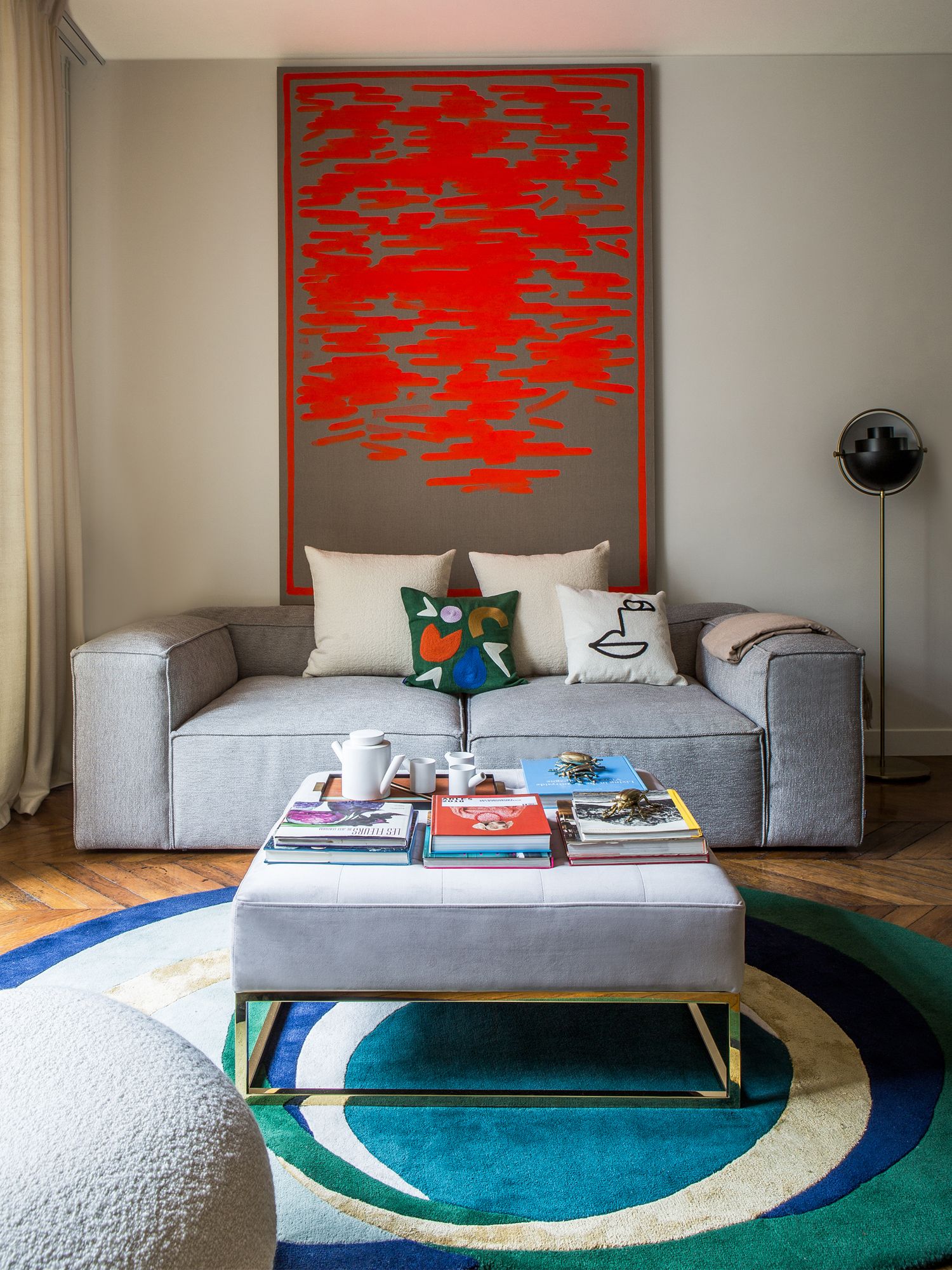 A cushy Bolia sofa sits under a painting by Hugo Capron from the Pauline Pavec Gallery in the living room, which exudes a sense of cosiness for the family to gather and unwind together