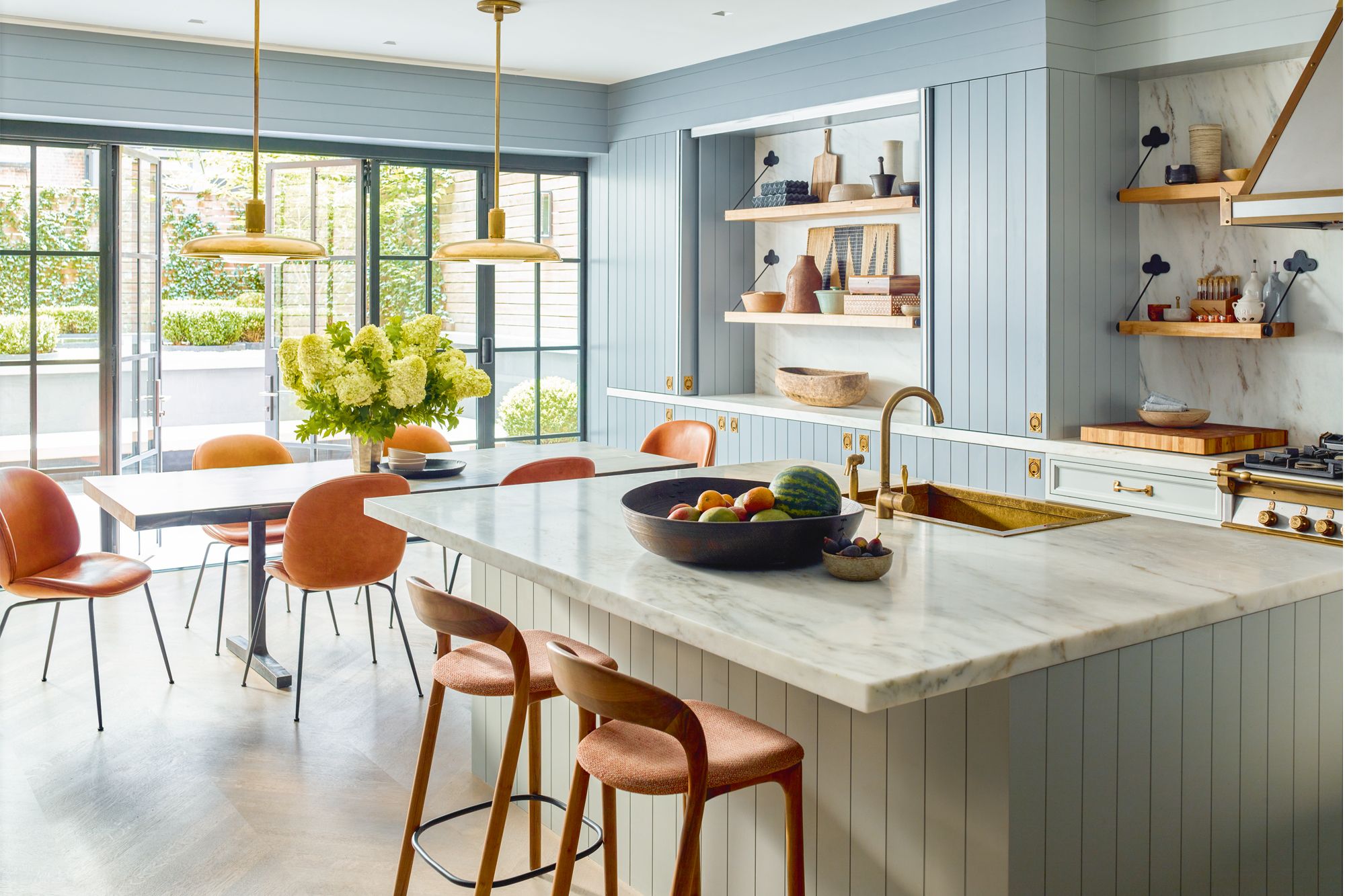 The folding patio doors at the open-plan dining and kitchen area lead to the stylish garden