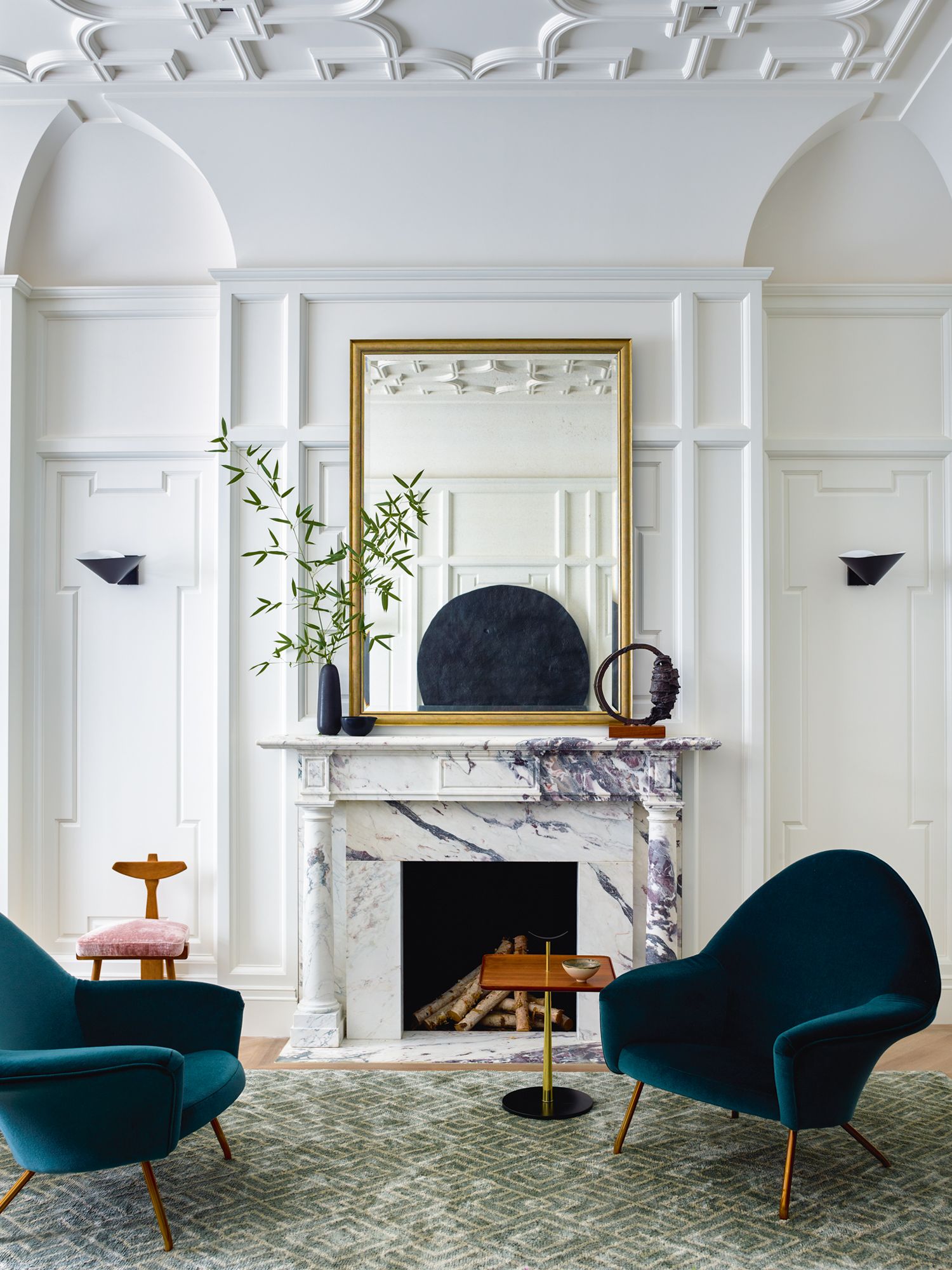 A cosy nook in front of the elegant fireplace allows the homeowners to enjoy a cup of tea