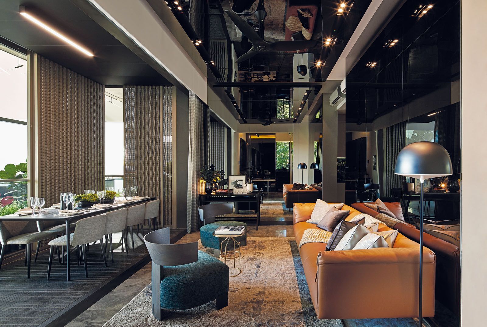 With its glossy surfaces, this living space designed by Peter Tay showcases how reflective elements can create lightness in a dark space Photography: Benny Loh