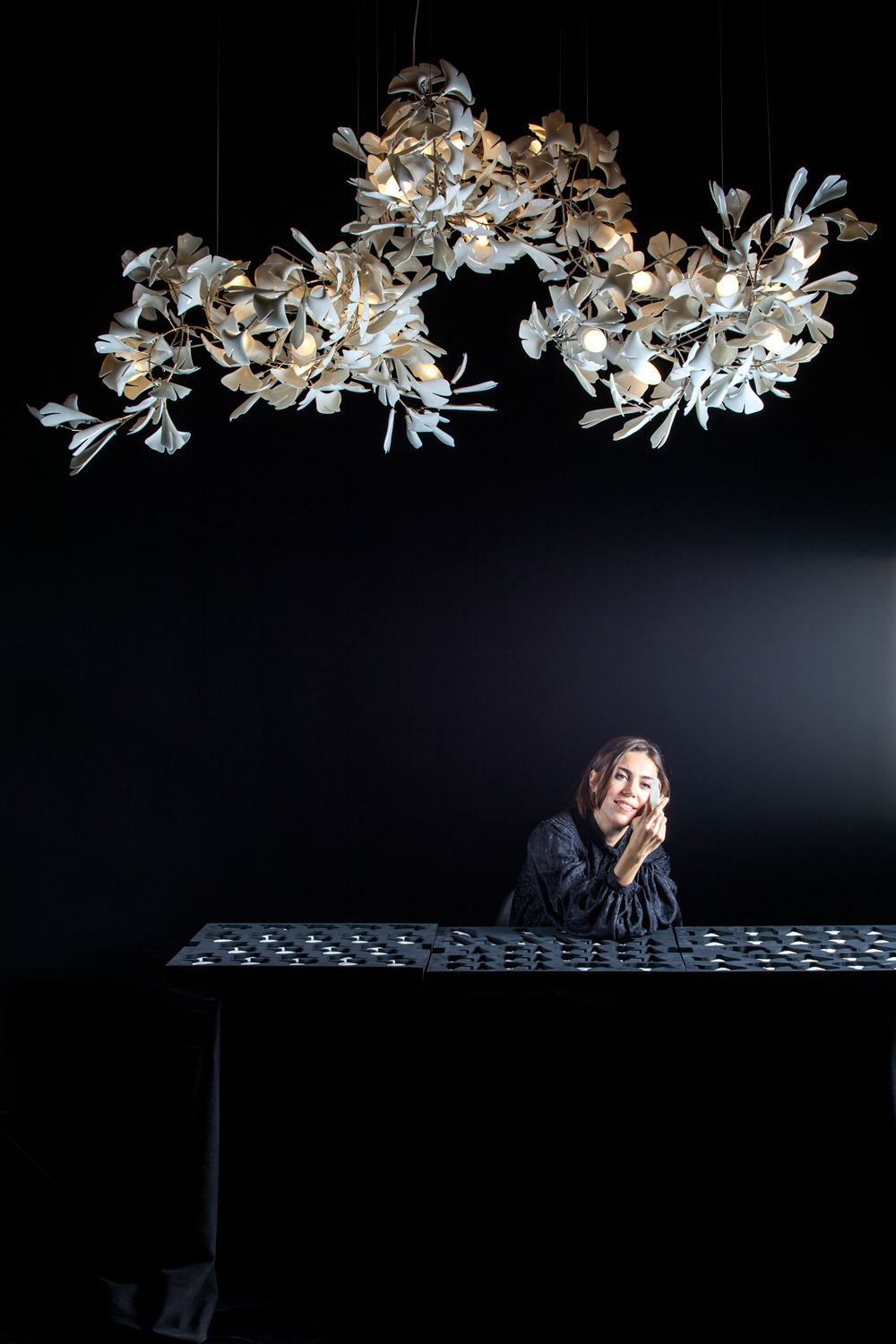 Romanian designer Andreea Braescu, pictured with her bespoke lighting piece Image: Courtesy of Andreea Braescu