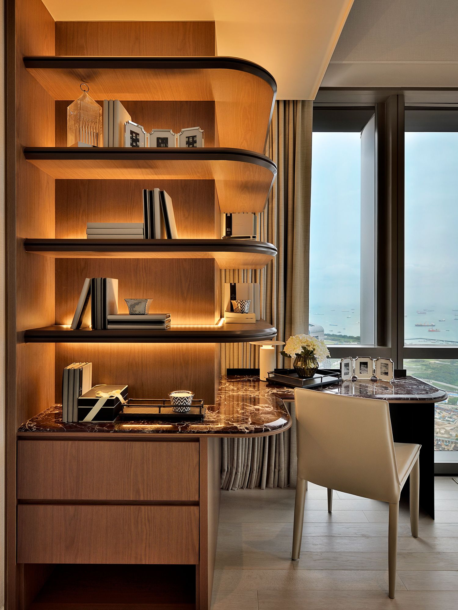 This beautifully designed interior features backlit shelves and textured rich marble surfaces