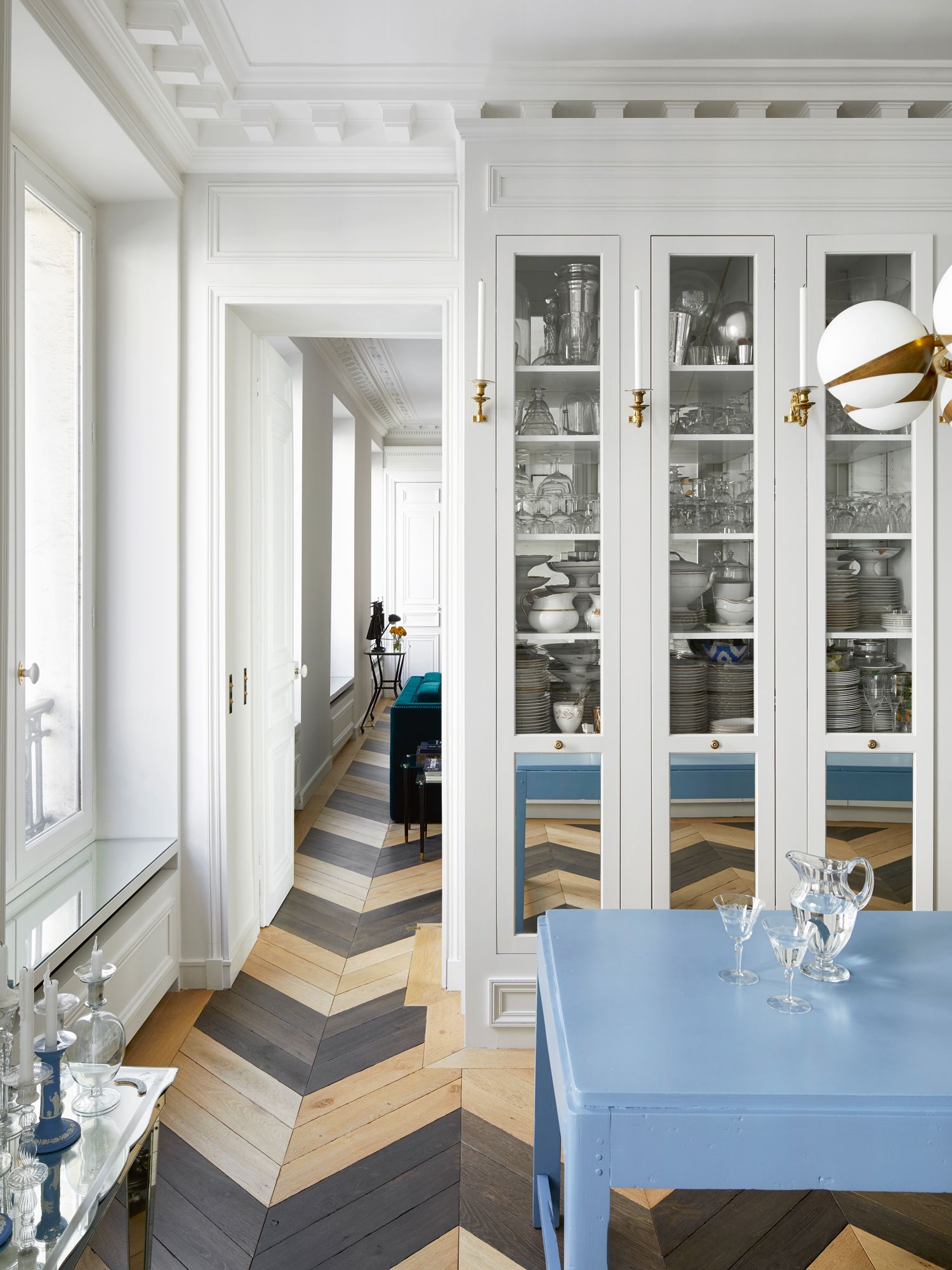 The herringbone flooring leads the eye towards the rest of the home