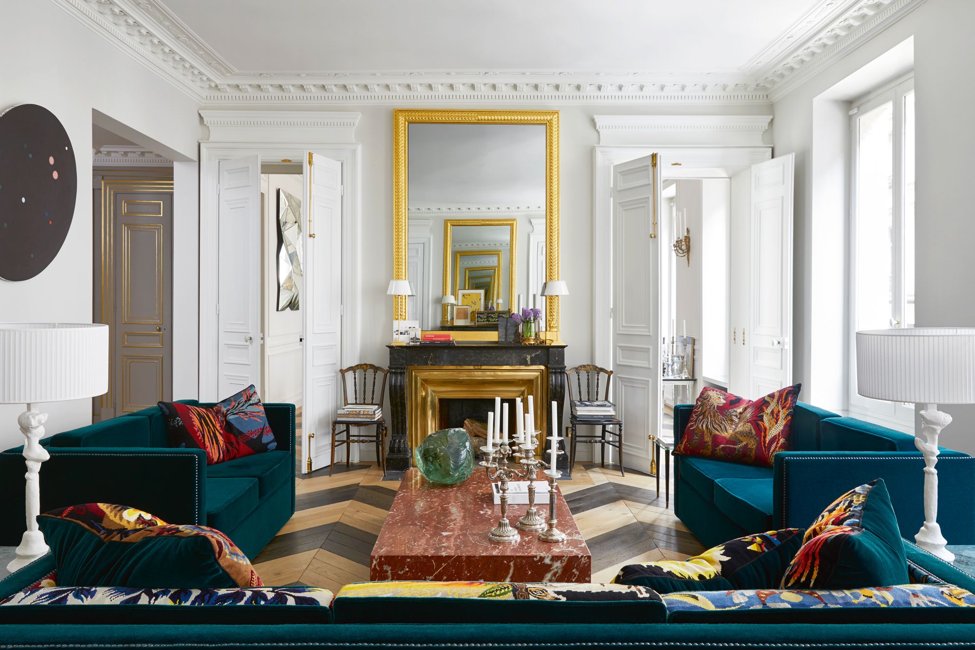 The red marble coffee table and velvet sofas were customised by fashion designer and homeowner Alexis Mabille, with the latter featuring vintage fabric offcuts from his womenswear collections