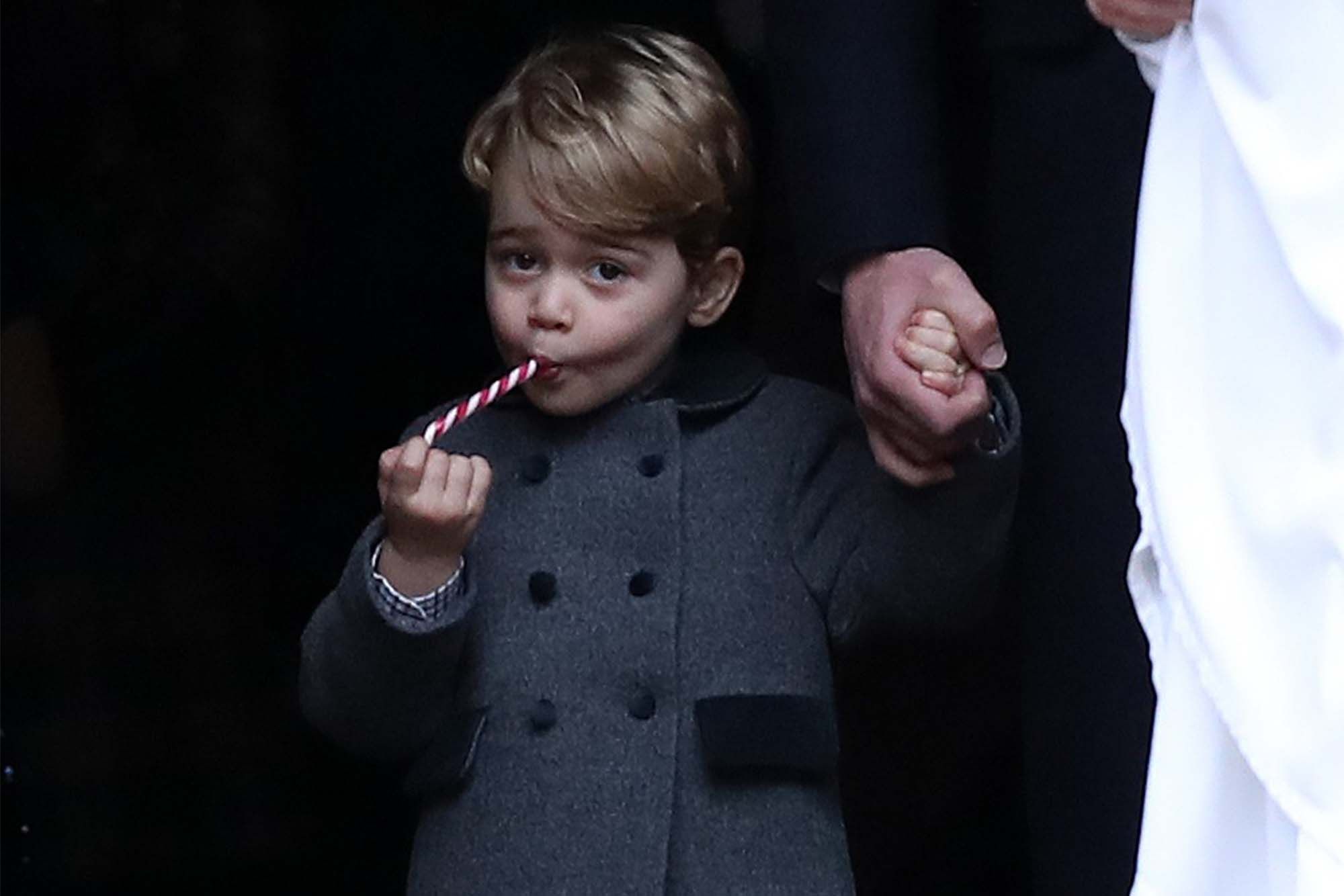 Prince George clearly could not be bothered with anything else while he ate a sweet after leaving a service at St Mark's Church on Christmas Day. (Photo: Getty Images)