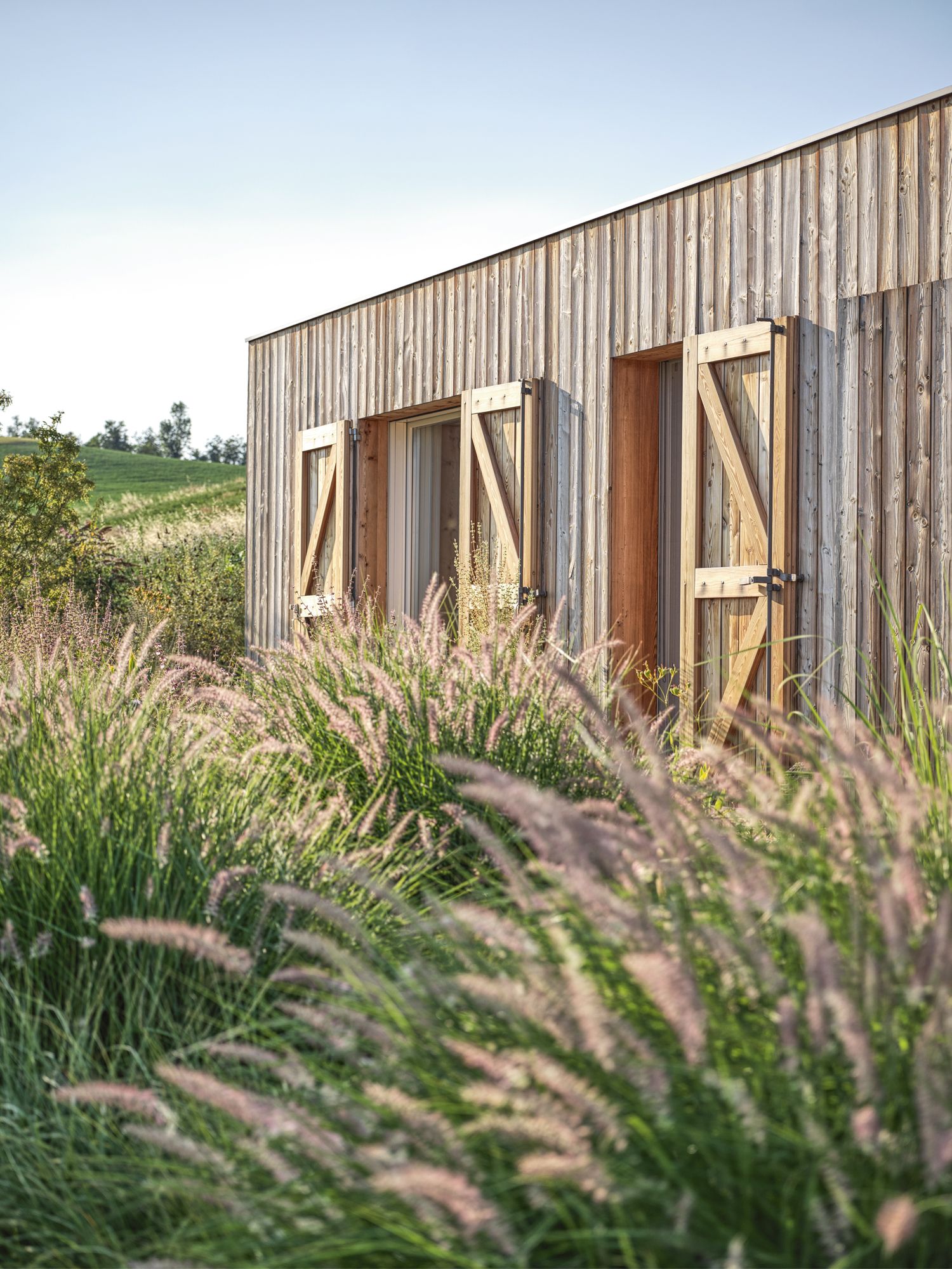 The house features kiln-dried natural larch wood sidings that will age to a weathered silver-grey hue