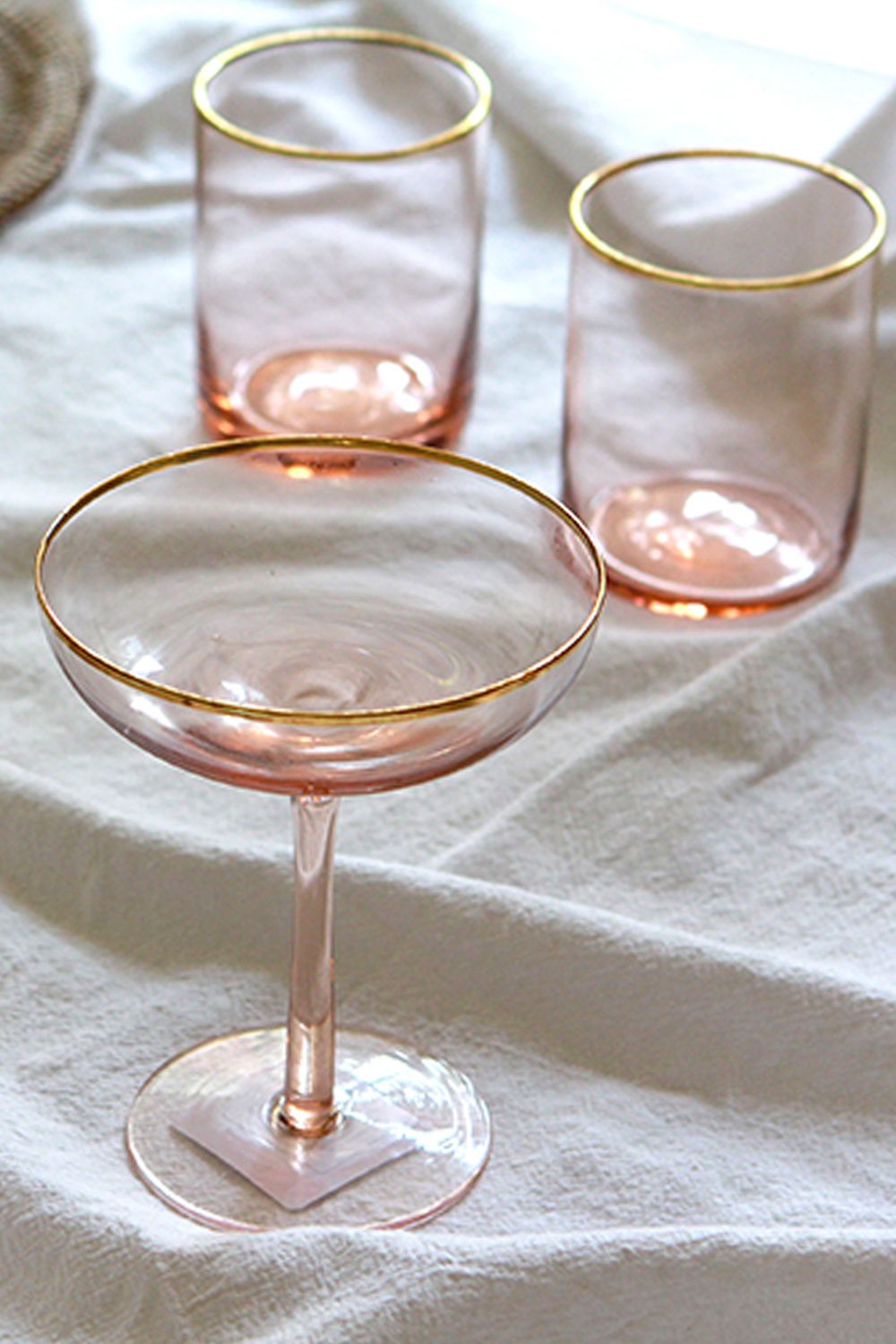 This rose pink cocktail glass (pictured front) from Snow Globe can double as a dessert glass Image: Courtesy of Snow Globe