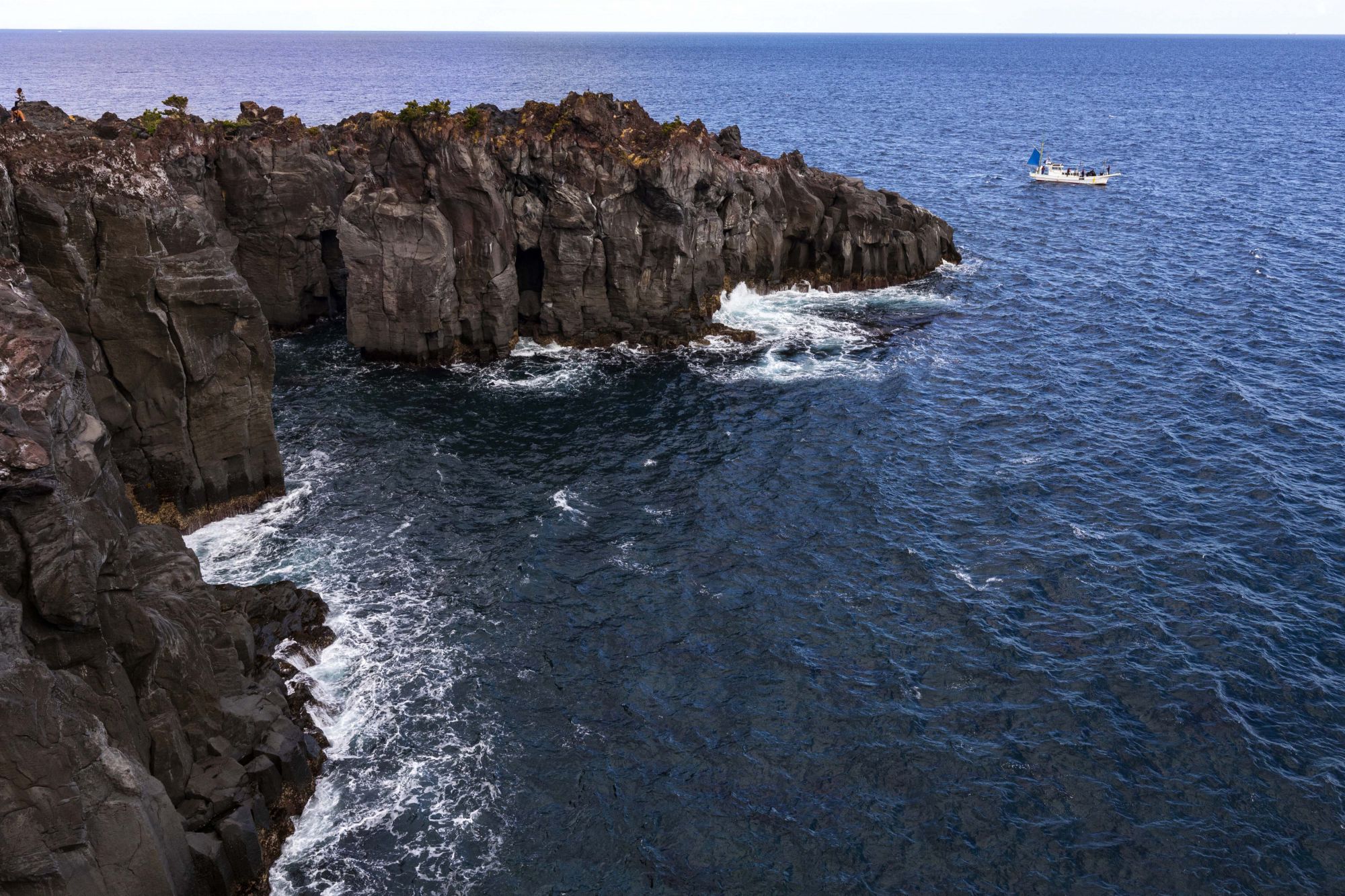 IZU PENINSULA, ITO, SHIZUOKA PREFECTURE, JAPAN - 2020/03/13: Cape Kadowaki - The stony coastline was created by an eruption of Mt. Omuro 4,000 years ago, while the lava flowed in the sea, then eroded by the tides and finally formed this scenery. The scenery is on such a wild scale, it lets visitors feel the power of nature. There is a hiking course of about 20 minutes along Jogasaki coast, which passes over the famous Kadowaki Suspension Bridge. (Photo by John S Lander/LightRocket via Getty Images)