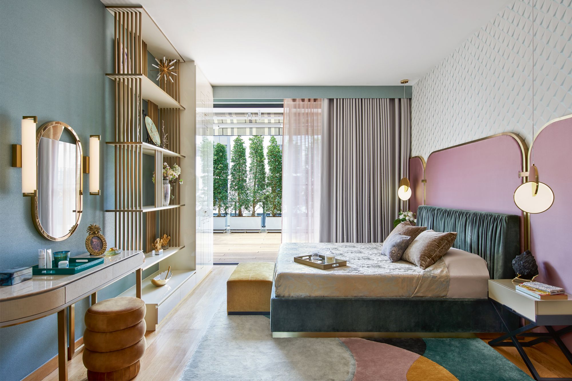 Gold trimmings on the furnishings and a geometric rug from Rugged Hospitality Solutions contribute to the sophisticated look of the master bedroom