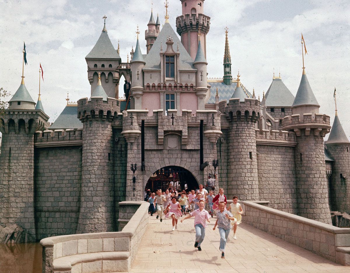 CALIFORNIA, UNITED STATES - JULY 1955: Children running through gate of Sleeping Beauty's Castle at Walt Disney's theme park, Disneyland. (Photo by Allan Grant/The LIFE Picture Collection via Getty Images)