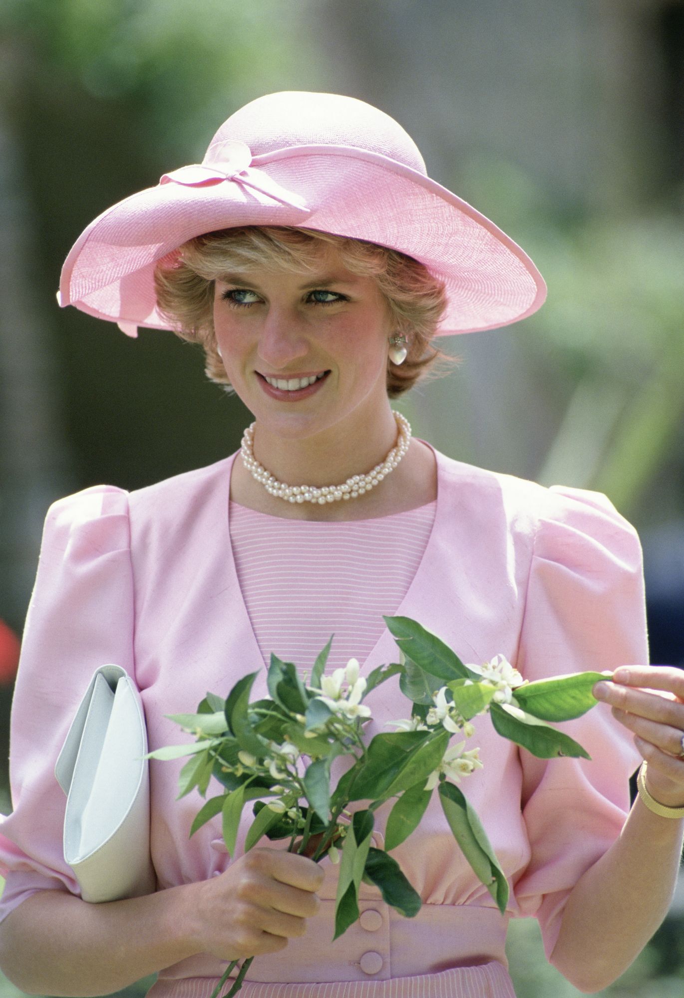 SICILY, ITALY - APRIL 30: Princess Diana In Sicily Holding Orange Blossom Flowers Wearing An Outfit Designed By Fashion Designer Catherine Walker And A Hat By Milliner John Boyd (Photo by Tim Graham Photo Library via Getty Images)
