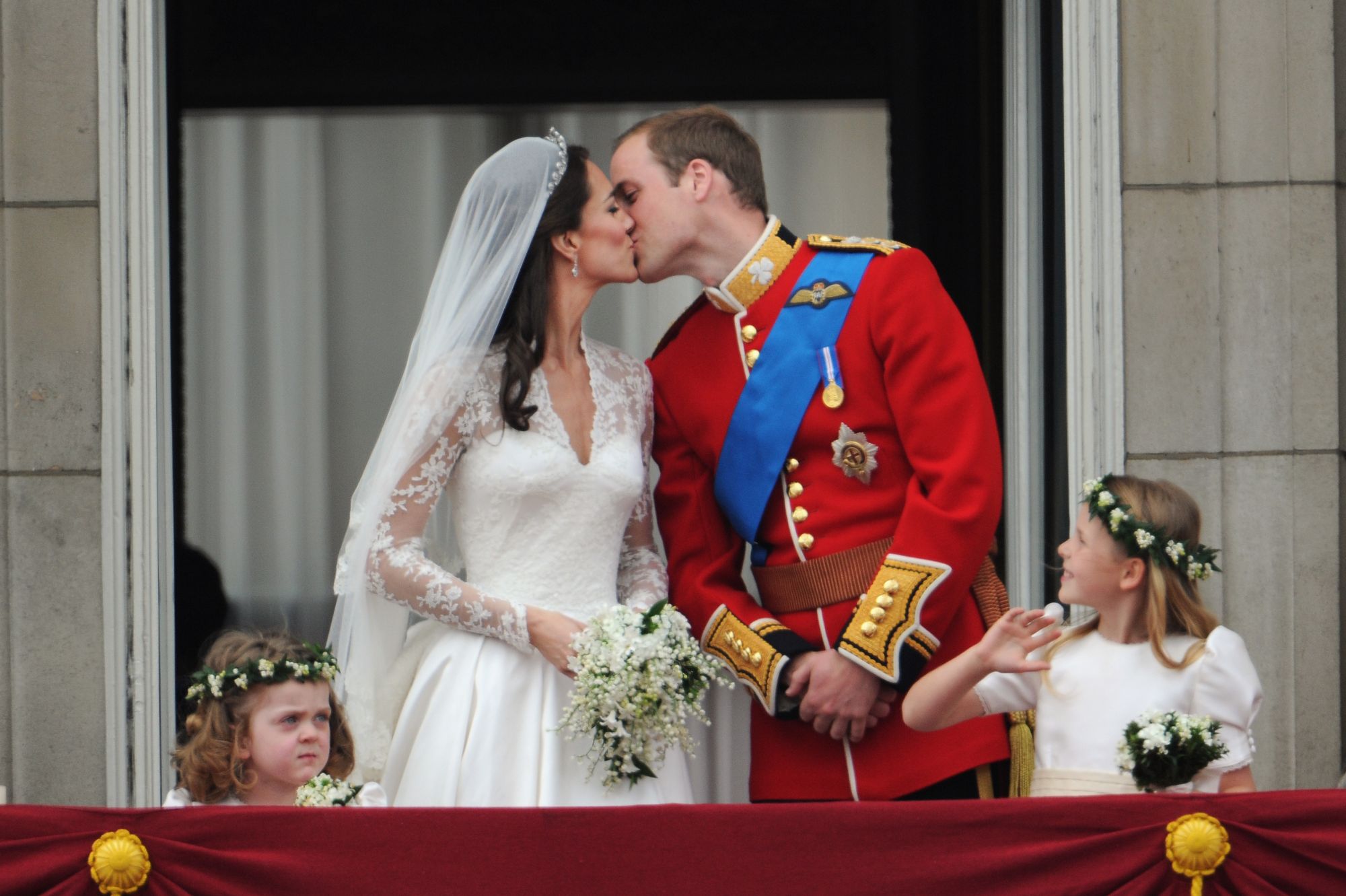 The Prince William of Wales kisses his new bride Catherine Elizabeth "Kate" on the balcony of Buckingha m Palace. The Prince and Princess of Wales greet the huge crowd after their wedding at Westminster Abbey. (Photo by Stephane Cardinale/Corbis via Getty Images)
