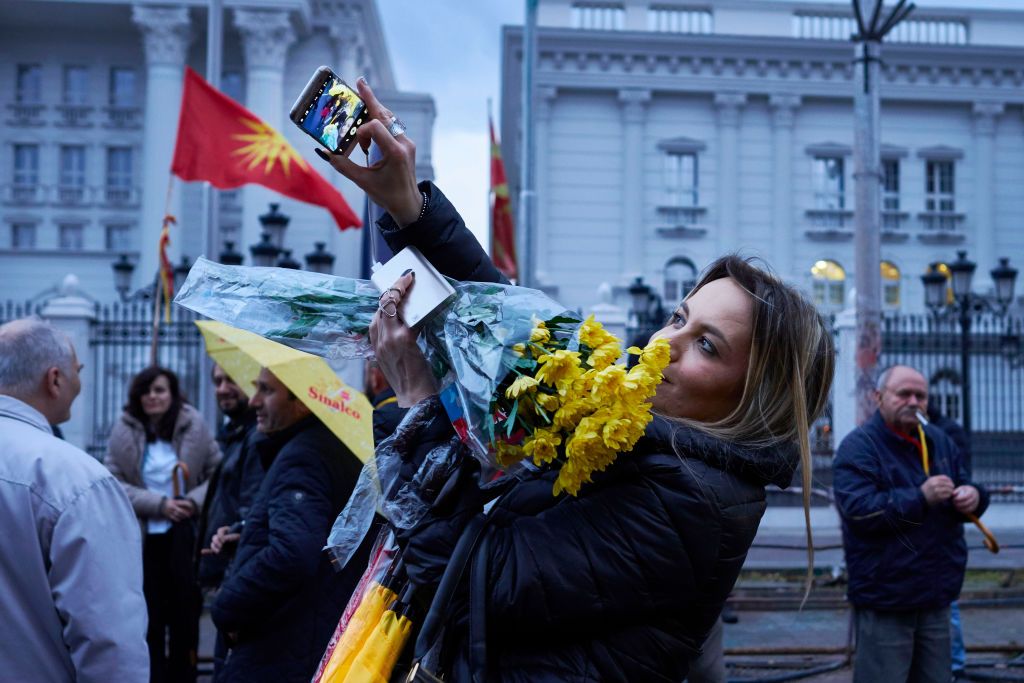 SKOPJE, MACEDONIA - MARCH 08: A woman takes a photo as she joins Macedonian nationalists marching to the parliament during a rally on Women's day on March 8, 2017 in Skopje, Macedonia. The political crisis deepens as the president refuses to grant the socialist democrats with a mandate in order to form a government with the Albanian parties. European and NATO officials are pressuring the president to give the mandate to the parliamentarian majority formed by the socialist democrats and Albanian parties. Rus