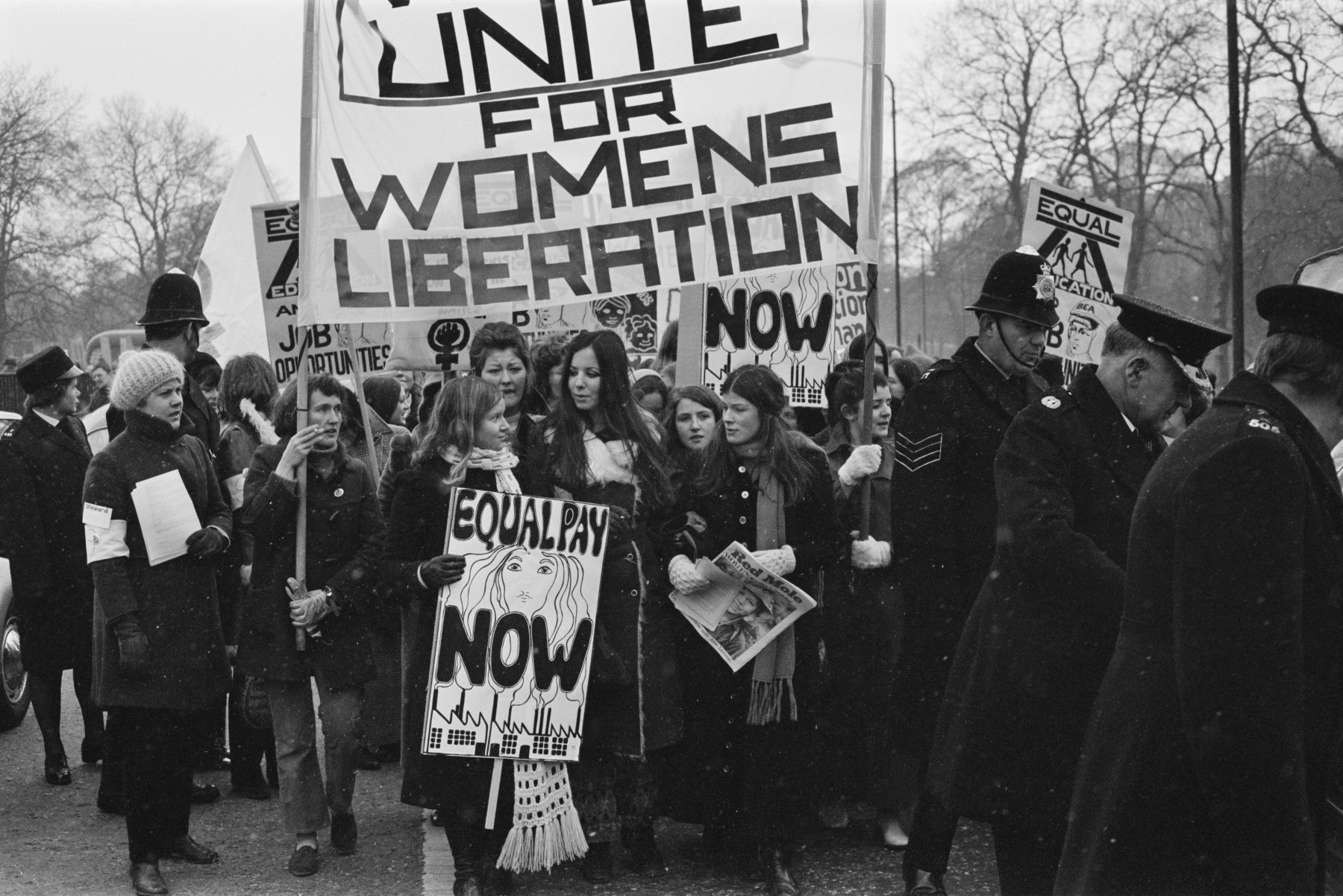 Members of the National Women's Liberation Movement, on an equal rights march from Speaker's Corner to No.10 Downing Street, to mark International Women's Day, London, 6th March 1971. One woman is carrying a placard reading 'Equal Pay Now'. On the right, a woman is holding a copy of the Trotskyist publication 'Red Mole'. (Photo by Daily Express/Hulton Archive/Getty Images)