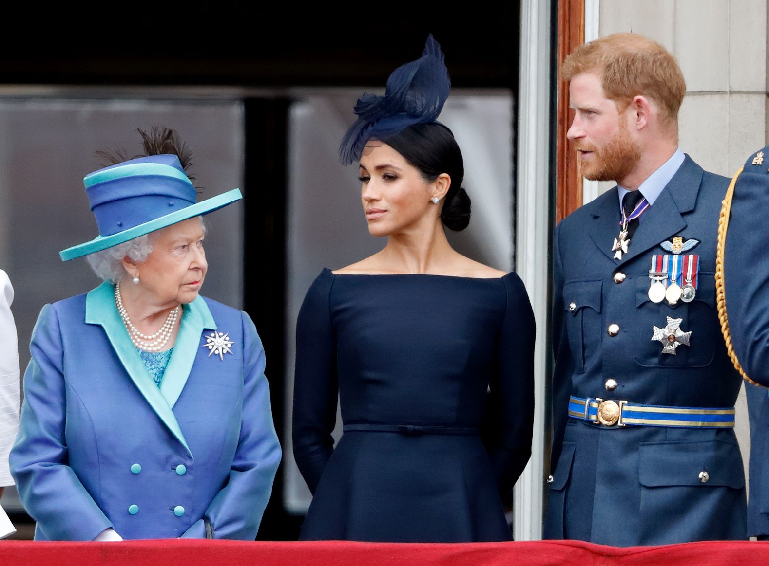 LONDON, UNITED KINGDOM - JULY 10: (EMBARGOED FOR PUBLICATION IN UK NEWSPAPERS UNTIL 24 HOURS AFTER CREATE DATE AND TIME) Queen Elizabeth II, Meghan, Duchess of Sussex and Prince Harry, Duke of Sussex watch a flypast to mark the centenary of the Royal Air Force from the balcony of Buckingham Palace on July 10, 2018 in London, England. The 100th birthday of the RAF, which was founded on on 1 April 1918, was marked with a centenary parade with the presentation of a new Queen's Colour and flypast of 100 aircraf