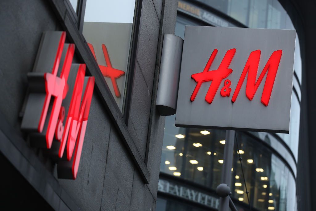 BERLIN, GERMANY - MARCH 28: The logo of Swedish clothing retailer H&M hangs over one of its stores on March 28, 2018 in Berlin, Germany. H&M, which is the world's second largest clothing retailer, announced yesterday it is struggling with plunging profits and rising inventories as popular demand for its clothes declines. (Photo by Sean Gallup/Getty Images)