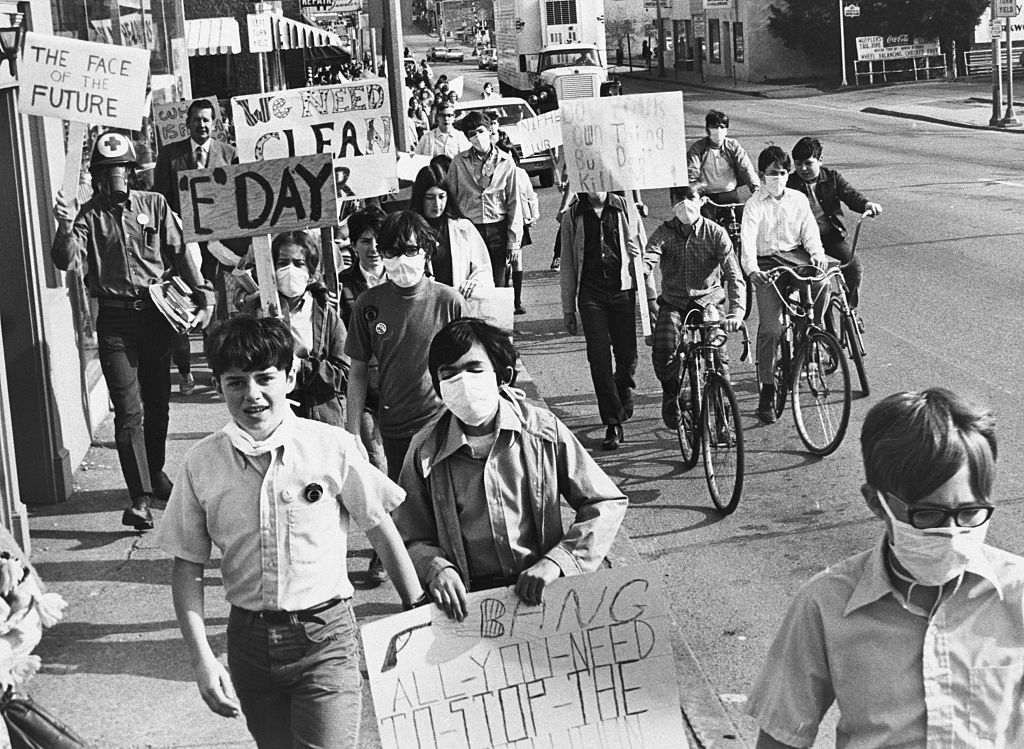 (Original Caption) ST. LOUIS-4/22/70-: Students at Nipher Junior High School marching through the business district of suburban Kirkwood 4/22 protesting against smog caused by automobiles. The demonstration was in connection with the observance of Earth Day. The Earth Day Environmental Teach-In here consisted of lectures, workshops, panel discussions, and debates on pollution, the population and other problems of ecology.
