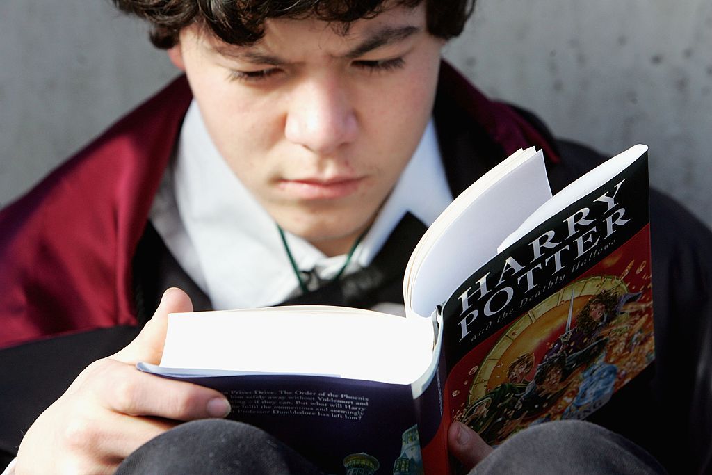 SYDNEY, AUSTRALIA - JULY 21: A Harry Potter fan begins to read the final novel by author J.K. Rowling, "Harry Potter and the Deathly Hallows, at the much anticipated launch on July 21, 2007 at the Carriage Works in Sydney Australia. Rowlings announced that it will be the seventh and final novel in the hugely successful Harry Potter series. The book went on sale in Australia at 9.01am on July 21, with children's and adults' hardbacks, an audio book and a deluxe gift edition being published simultaneously acc