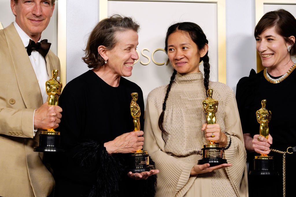 LOS ANGELES, CALIFORNIA - APRIL 25: (L-R) Peter Spears, Frances McDormand, Chloe Zhao and Mollye Asher, winners of Best Picture for "Nomadland," pose in the press room at the Oscars on Sunday, April 25, 2021, at Union Station in Los Angeles. (Photo by Chris Pizzello-Pool/Getty Images)