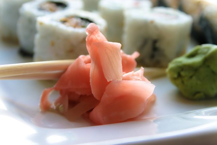 Sushi platter with wooden chopsticks, ginger and wasabi.