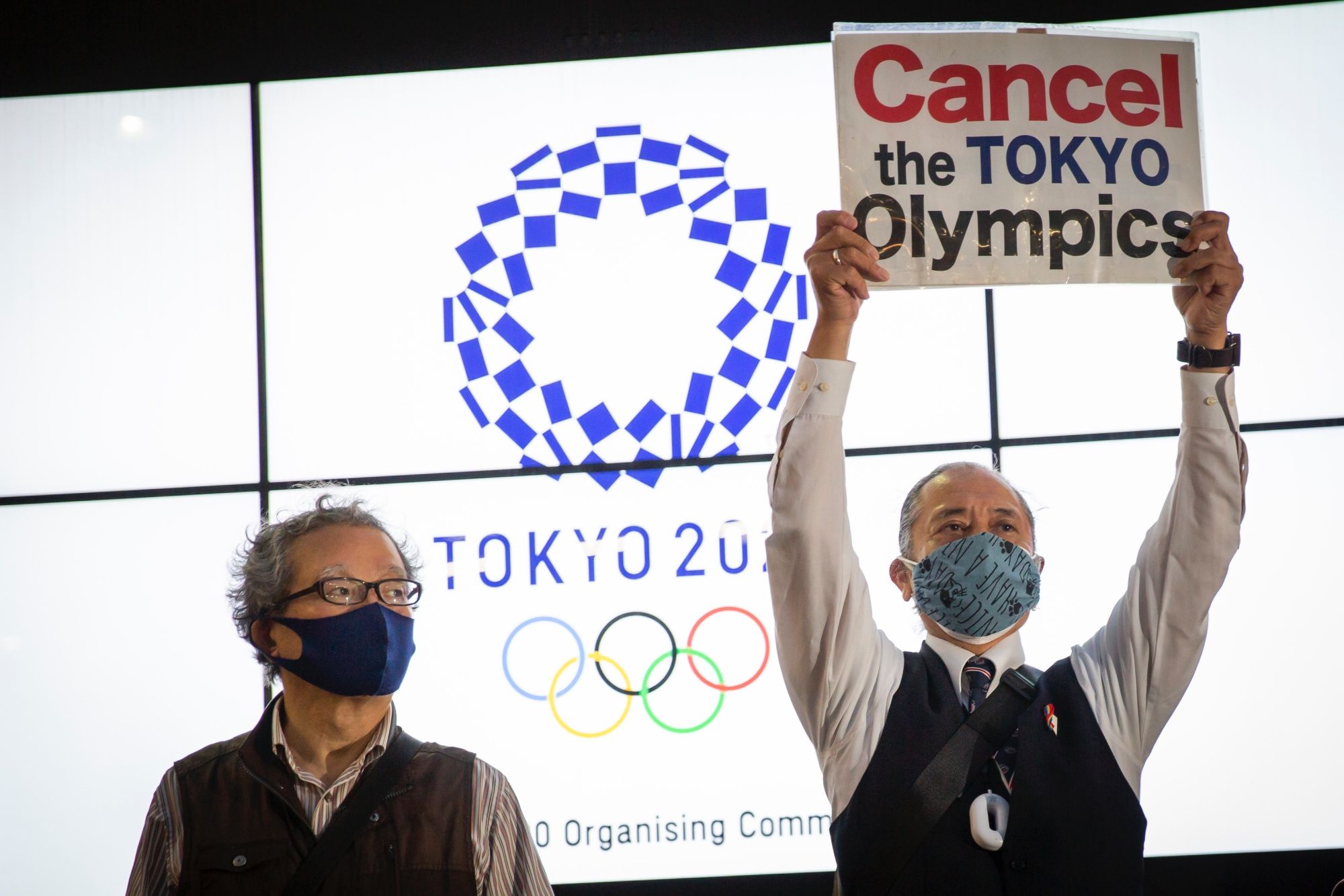 TOKYO, JAPAN - MAY 17: A protester holds a placard during a protest against the Tokyo Olympics on May 17, 2021 in Tokyo, Japan. With less than 3 months remaining until the Tokyo Olympics, a recent survey has indicated that around 60 percent of Japanese people do not want the Games to go ahead. Although it marks a drop in an earlier survey in which around 80 percent of people believed the Olympics and Paralympics should be cancelled or rescheduled, concern continues to linger in Japan over the feasibility of