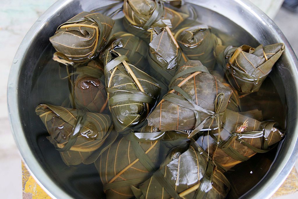 NINGQIANG COUNTY, CHINA - JUNE 8: (CHINA OUT) 'Zongzi' (glutinous rice dumplings) are served in a restaurant on Duanwu Festival, or the Dragon Boat Festival on June 8, 2008 in Ningqiang County of Shaanxi Province, China. The Duanwu Festival is celebrated throughout China every year with activities such as boat races and the eating of Zongzi. The festival falls on the fifth day of the fifth lunar month and was established in remembrance of Qu Yuan, a patriotic poet who committed suicide in the Miluo River on