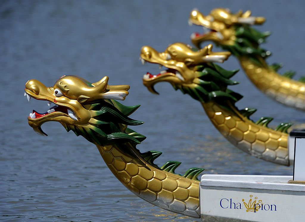 The 11th annual Colorado Dragon Boat festival continued today July 31,2011 at Sloan's Lake in Denver, with temperatures soaring into the triple digits. Dragon boat racing is over 2,000 years old and is steeped in Chinese tradition. At the festival there are two types of boats that were used this year. The Taiwan style boat aka Flag Catching boats, where boats race to capture a flag at the end. They race in pairs. The second style is the international standard Hong Kong style boat where three boats race agai