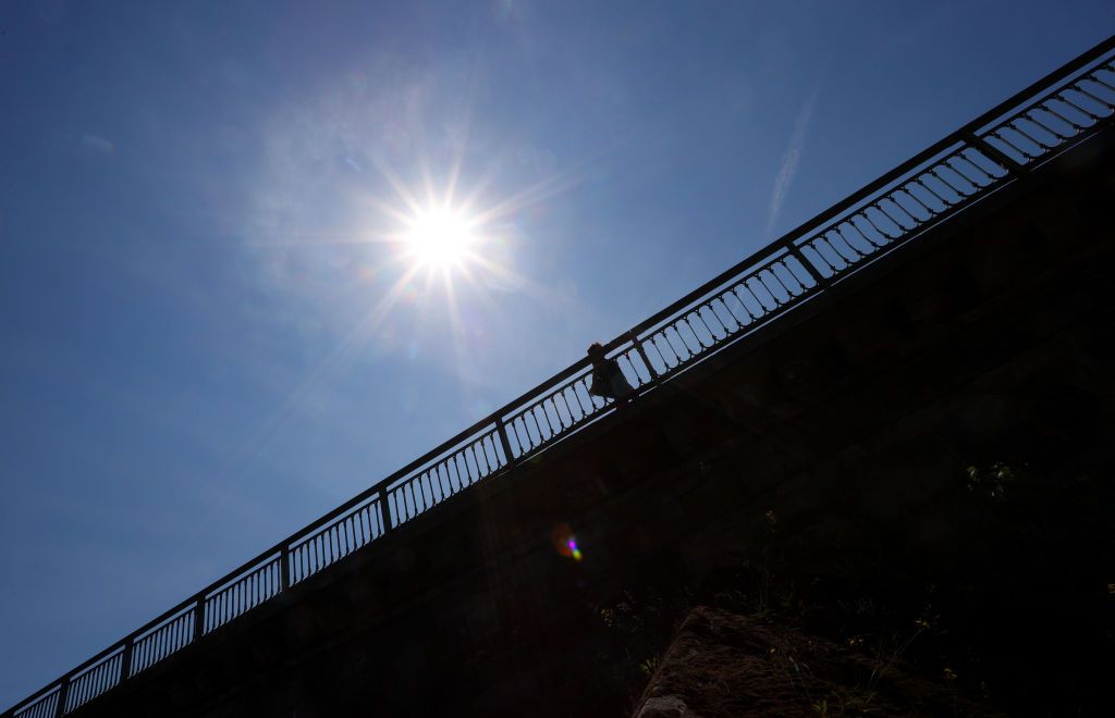 18 June 2021, Bavaria, Kitzingen: A woman walks across the Main bridge in the sunshine. Photo: Karl-Josef Hildenbrand/dpa (Photo by Karl-Josef Hildenbrand/picture alliance via Getty Images)