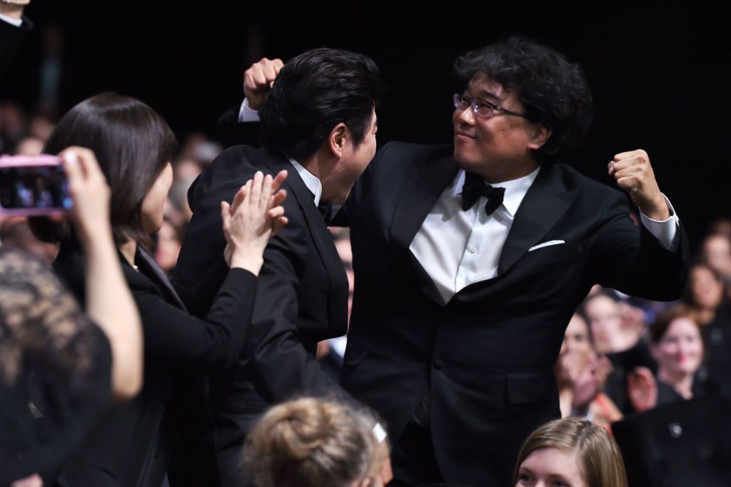 CANNES, FRANCE - MAY 25: Director Bong Joon-Ho (L) reacts after winning the Palme d'Or award for "Parasite" during the Closing Ceremony of the 72nd annual Cannes Film Festival on May 25, 2019 in Cannes, France. (Photo by Pascal Le Segretain/Getty Images)