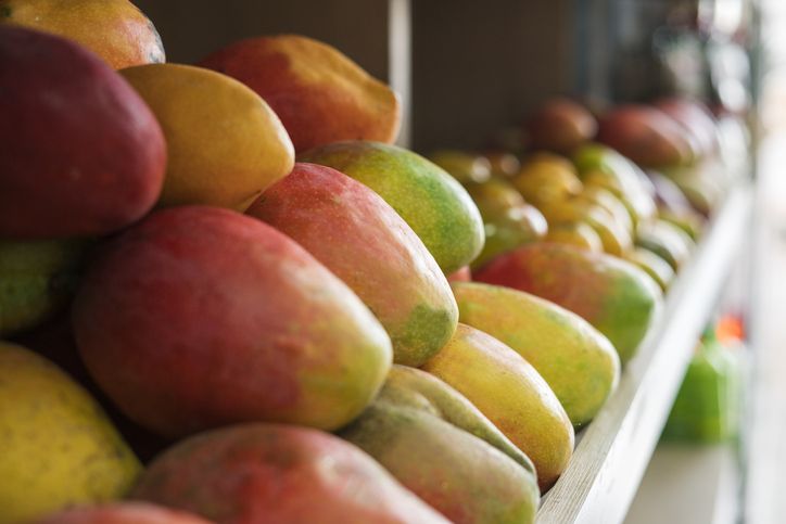 fruits on supermarket counter all with good presentation and green and yellow color.Peach on supermarket counter