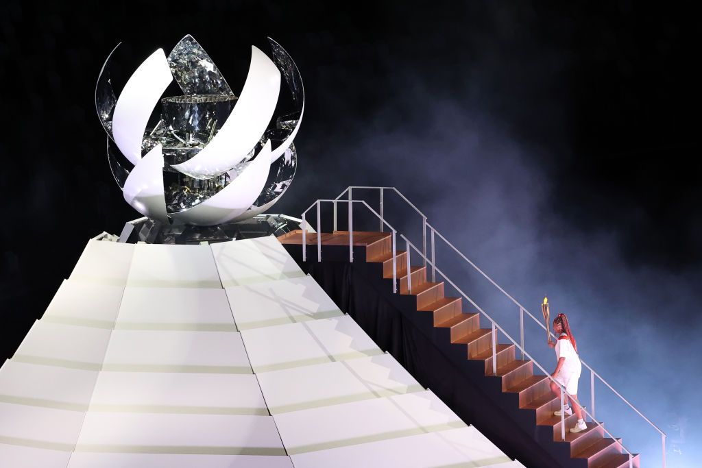 TOKYO, JAPAN JULY 23, 2021: Tennis player Naomi Osaka lights the Olympic Cauldron atop a mini Mount Fuji at the opening ceremony of the Tokyo 2020 Summer Olympic Games at the National Stadium. Tokyo was to host the 2020 Summer Olympics from 24 July to 9 August 2020, however because of the COVID-19 pandemic the games have been postponed for a year and are due to take place from 23 July to 8 August 2021. Stanislav Krasilnikov/TASS (Photo by Stanislav Krasilnikov\TASS via Getty Images)