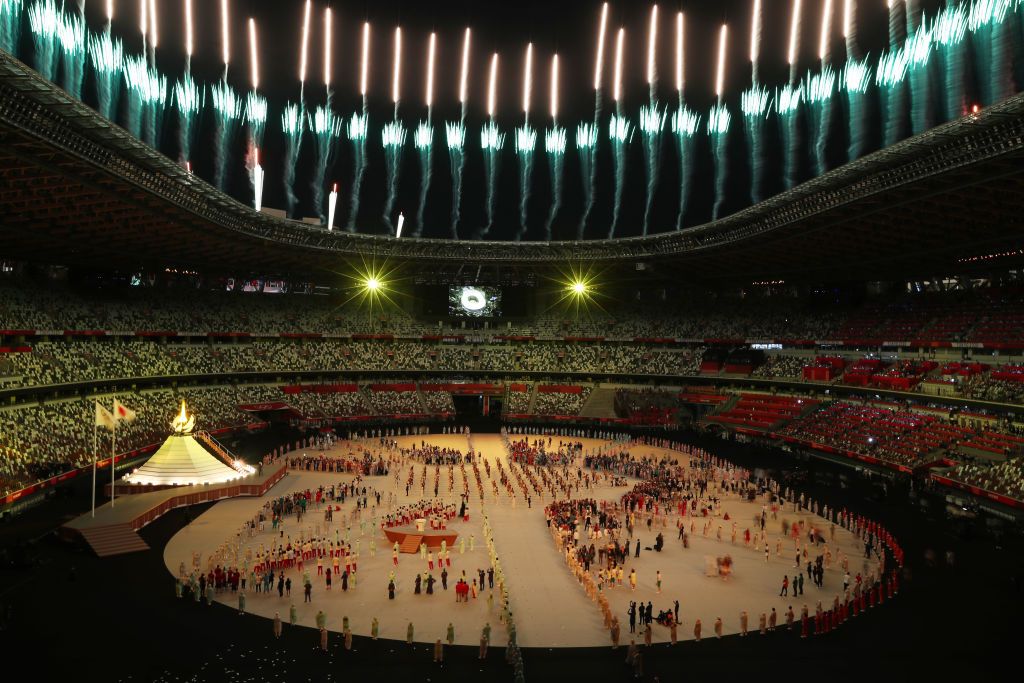 TOKYO, JAPAN JULY 23, 2021: Fireworks go off over the lit Olympic Cauldron atop a mini Mount Fuji at the opening ceremony of the Tokyo 2020 Summer Olympic Games at the National Stadium. Tokyo was to host the 2020 Summer Olympics from 24 July to 9 August 2020, however because of the COVID-19 pandemic the games have been postponed for a year and are due to take place from 23 July to 8 August 2021. Stanislav Krasilnikov/TASS (Photo by Stanislav Krasilnikov\TASS via Getty Images)
