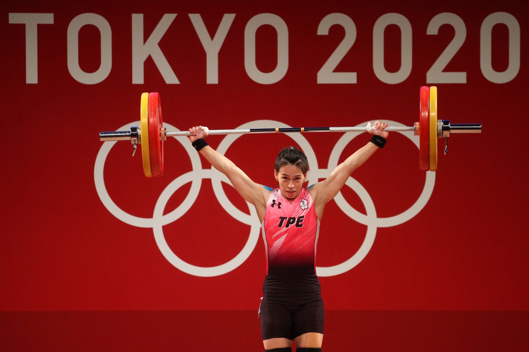 TOKYO, JAPAN - JULY 27: Hsing-Chun Kuo of Team Chinese Taipei competes during the Weightlifting - Women's 59kg Group A on day four of the Tokyo 2020 Olympic Games at Tokyo International Forum on July 27, 2021 in Tokyo, Japan. (Photo by Chris Graythen/Getty Images)