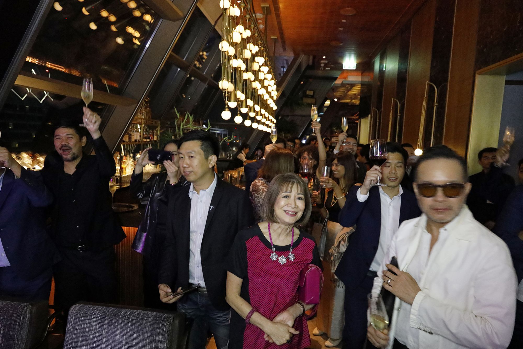 The crowd toasts the list
