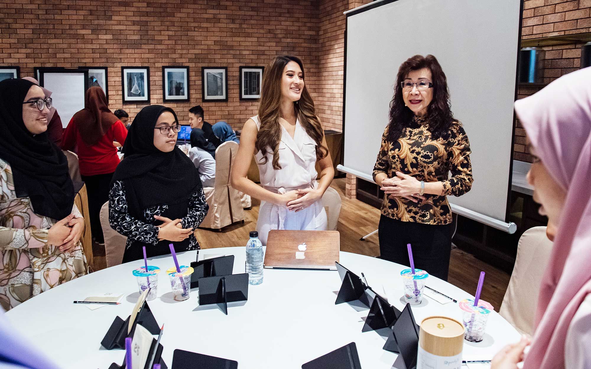 Raja Jesrina Arshad and Florence Fang in a breathing exercise demonstration.