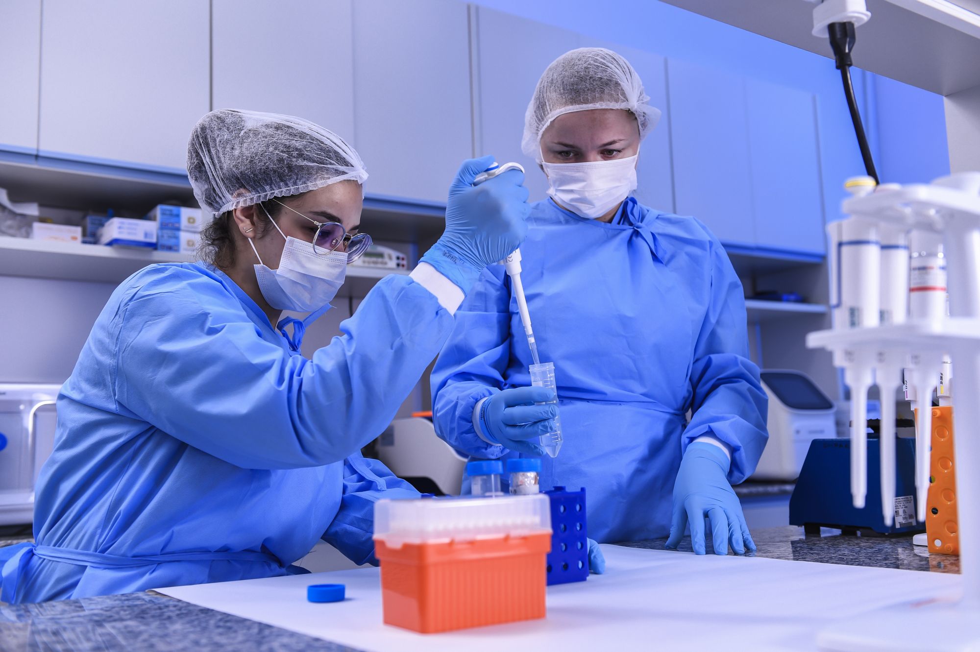 BELO HORIZONTE, BRAZIL - MARCH 24: Andressa Parreiras, Biomedic, and Larissa Vuitika, biologist, work in a laboratory during the extraction of the virus genetic material on March 24, 2020 in Belo Horizonte, Brazil. The Ministry of Health convened The Technological Vaccine Center of the Federal University of Minas Gerais laboratory to conduct research on the coronavirus (COVID-19) in order to diagnose, test and develop a vaccine. According to the Ministry of Health, as of Tuesday, March 24, Brazil has 1.89