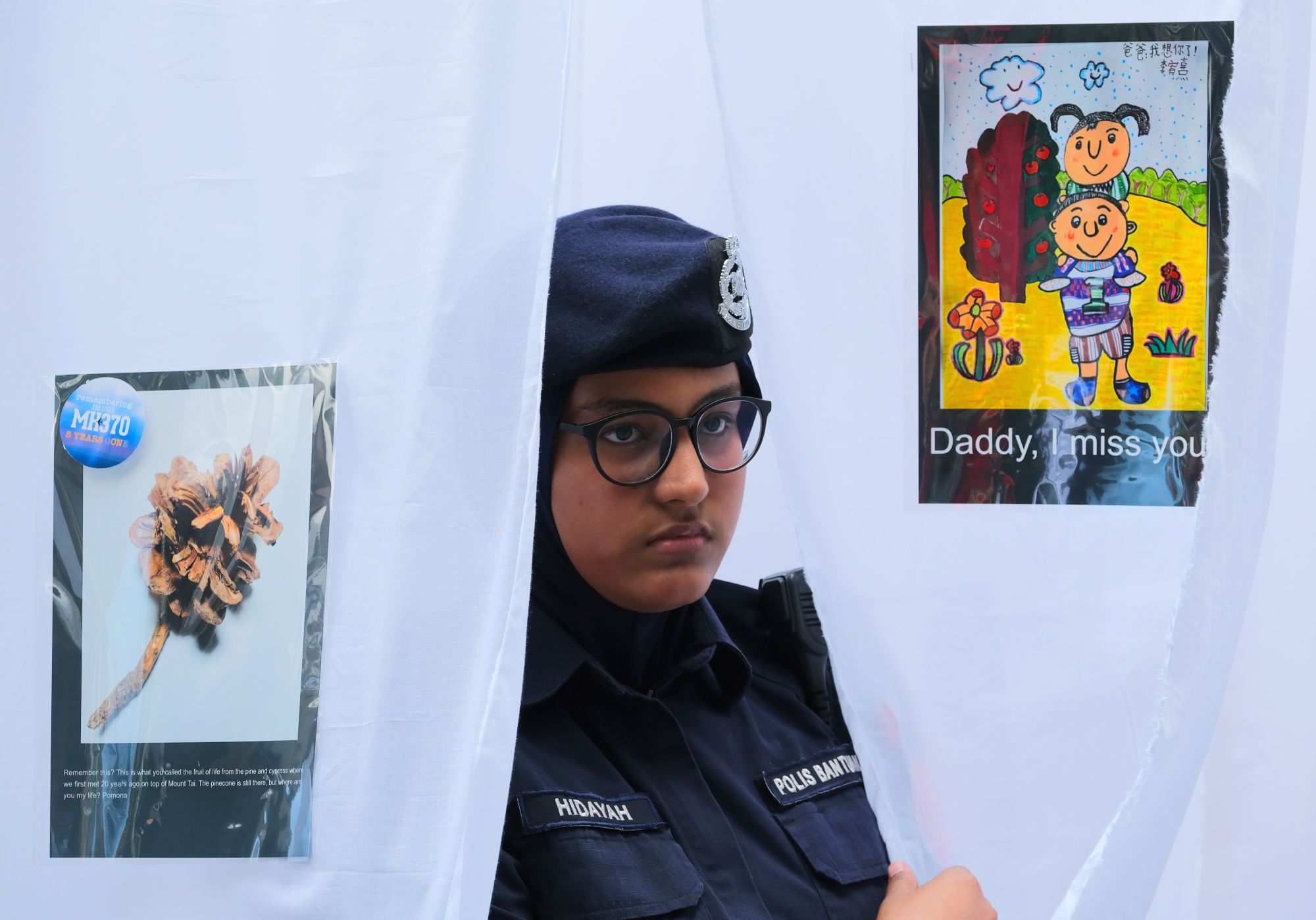 KUALA LUMPUR, MALAYSIA - MARCH 03: A Malaysian police officer is seen at an art installation of the last belongings of passengers onboard the missing Malaysia Airlines flight MH370 during a 5 Years of Remembrance for Malaysian Airlines MH370 event on March 3, 2019 in Kuala Lumpur, Malaysia. The Boeing 777-200 plane heading from Kuala Lumpur to Beijing with 239 passengers and crew went missing on March 8, 2014. According to Malaysias transport minister Anthony Loke, government is waiting for a fresh propos