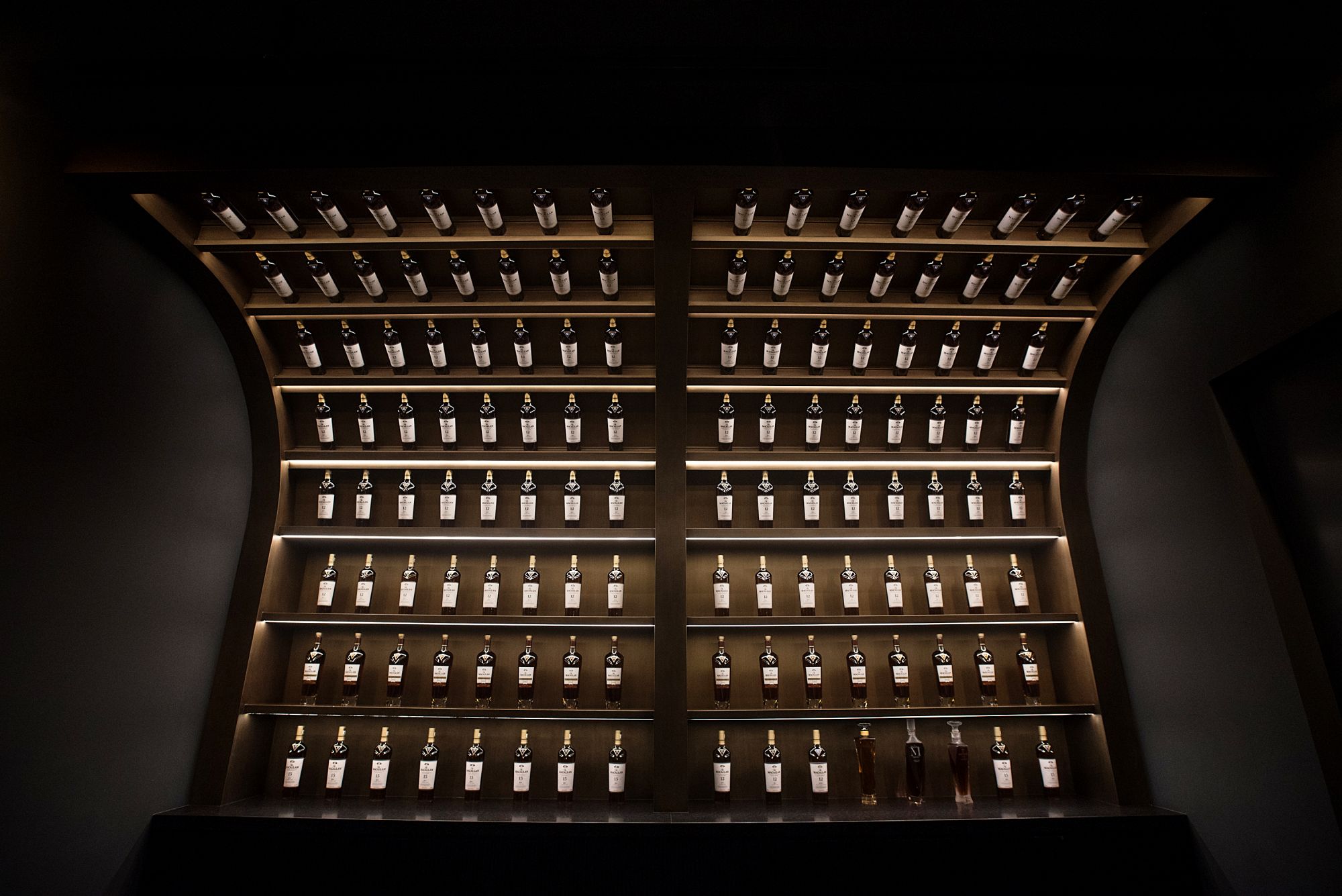 A display wall of whisky bottles at The Macallan Experience