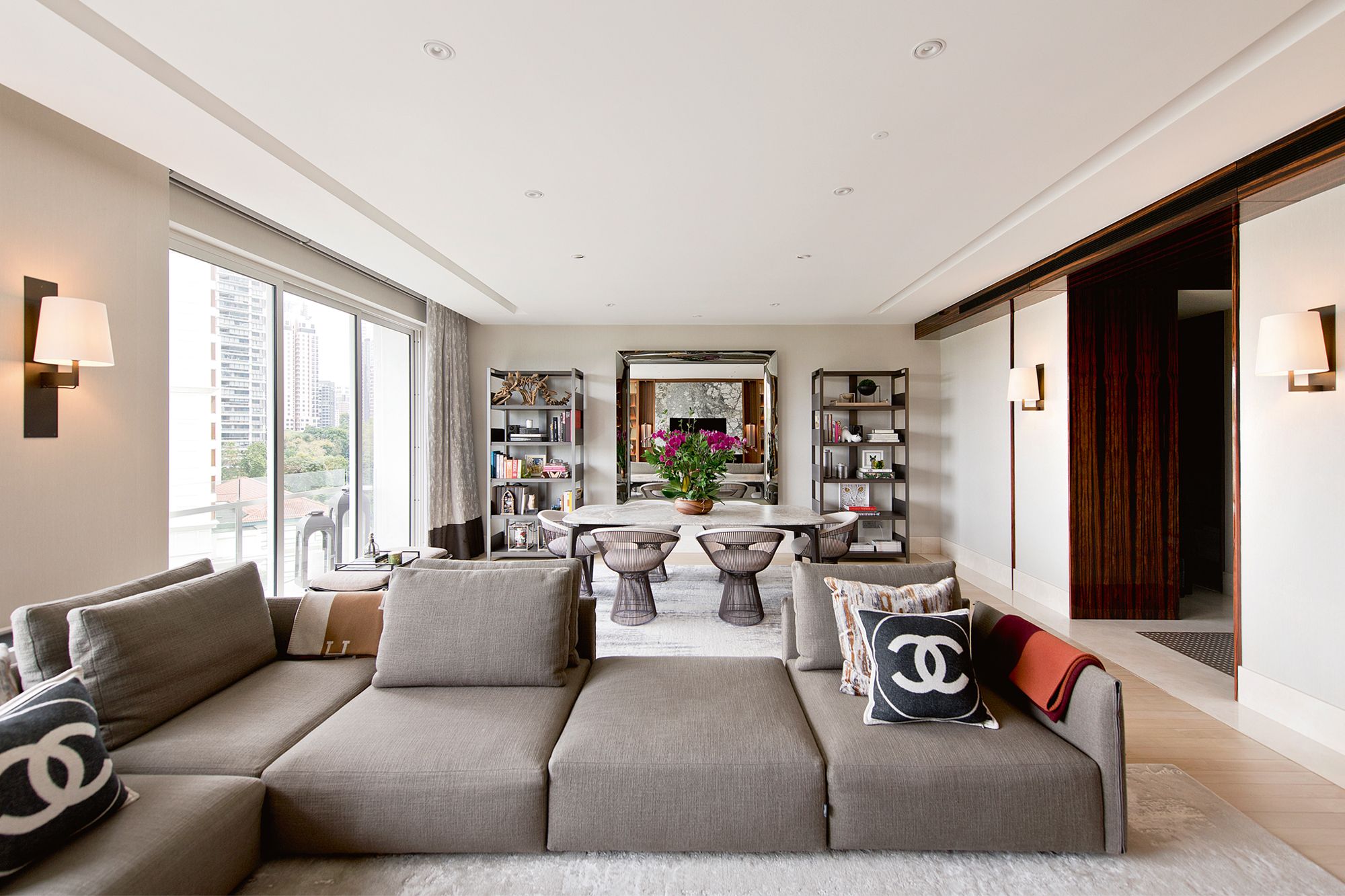 A large mirror from Fiam Italia expands the sense of space in the open-plan living and dining areas