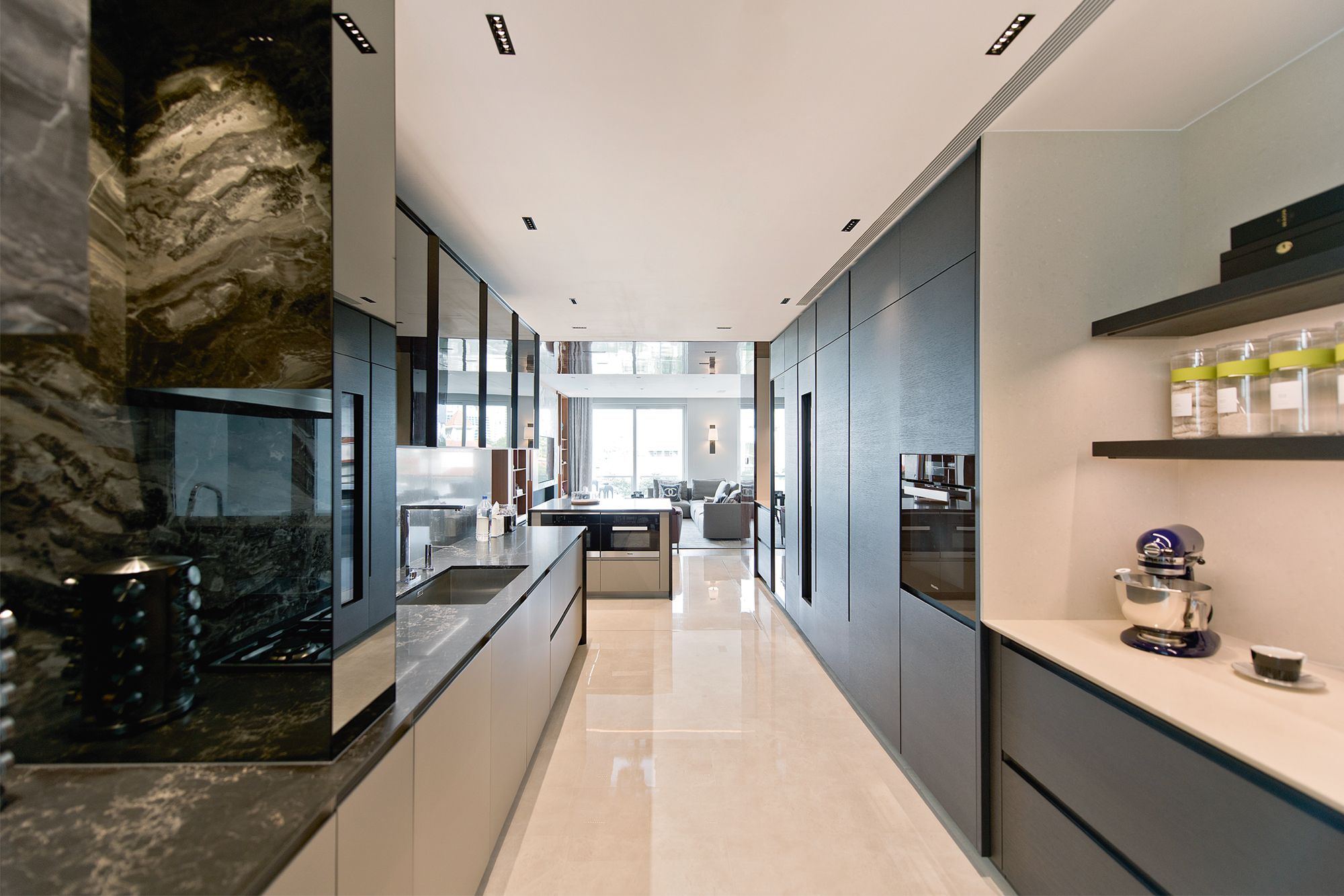 The kitchen is fitted with sleek cabinetry from Poliform