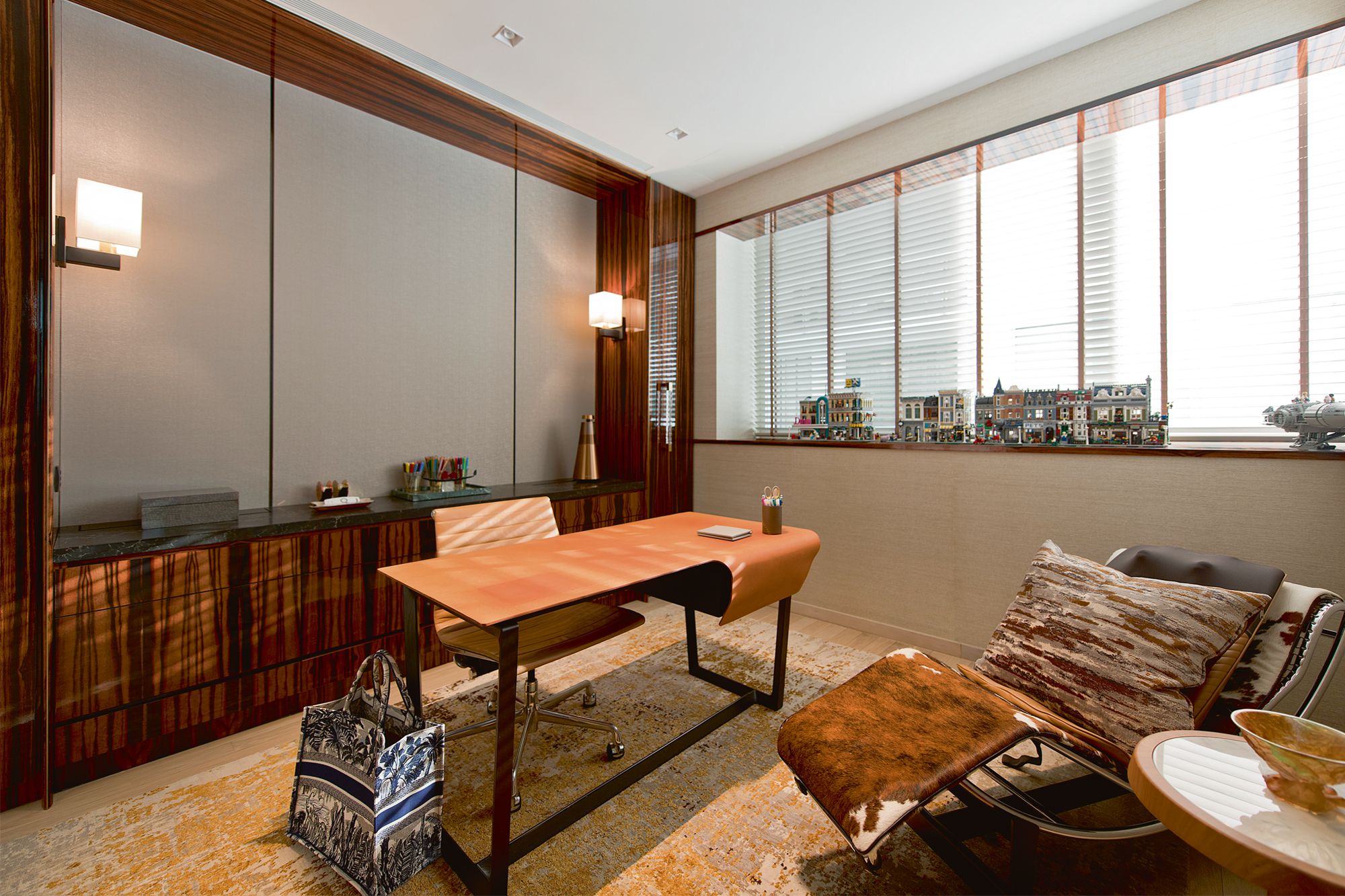 The mix of leather and wood on furnishings such as the Poltrona Frau Fred desk by Roberto Lazzeroni and the Cassina LC4 chaise longue by Charlotte Perriand contribute to the study’s cocooning ambience