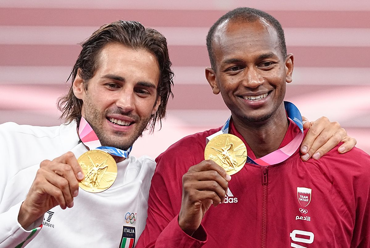 02 August 2021, Japan, Tokio: Athletics: Olympics, high jump, men, final, at the Olympic Stadium. Mutaz Essa Barshim (r) from Qatar and Gianmarco Tamberi from Italy stand together with their gold medals during the award ceremony. Photo: Michael Kappeler/dpa (Photo by Michael Kappeler/picture alliance via Getty Images)
