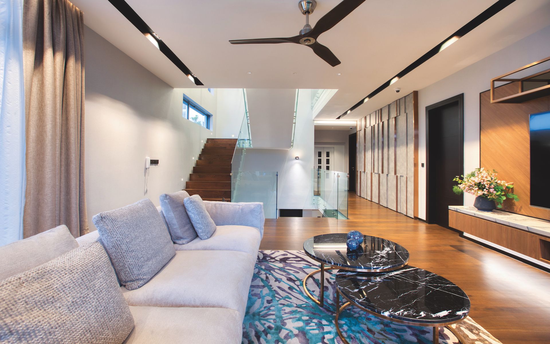 The family area has a cozy Flexform Zeno sofa to curl up to