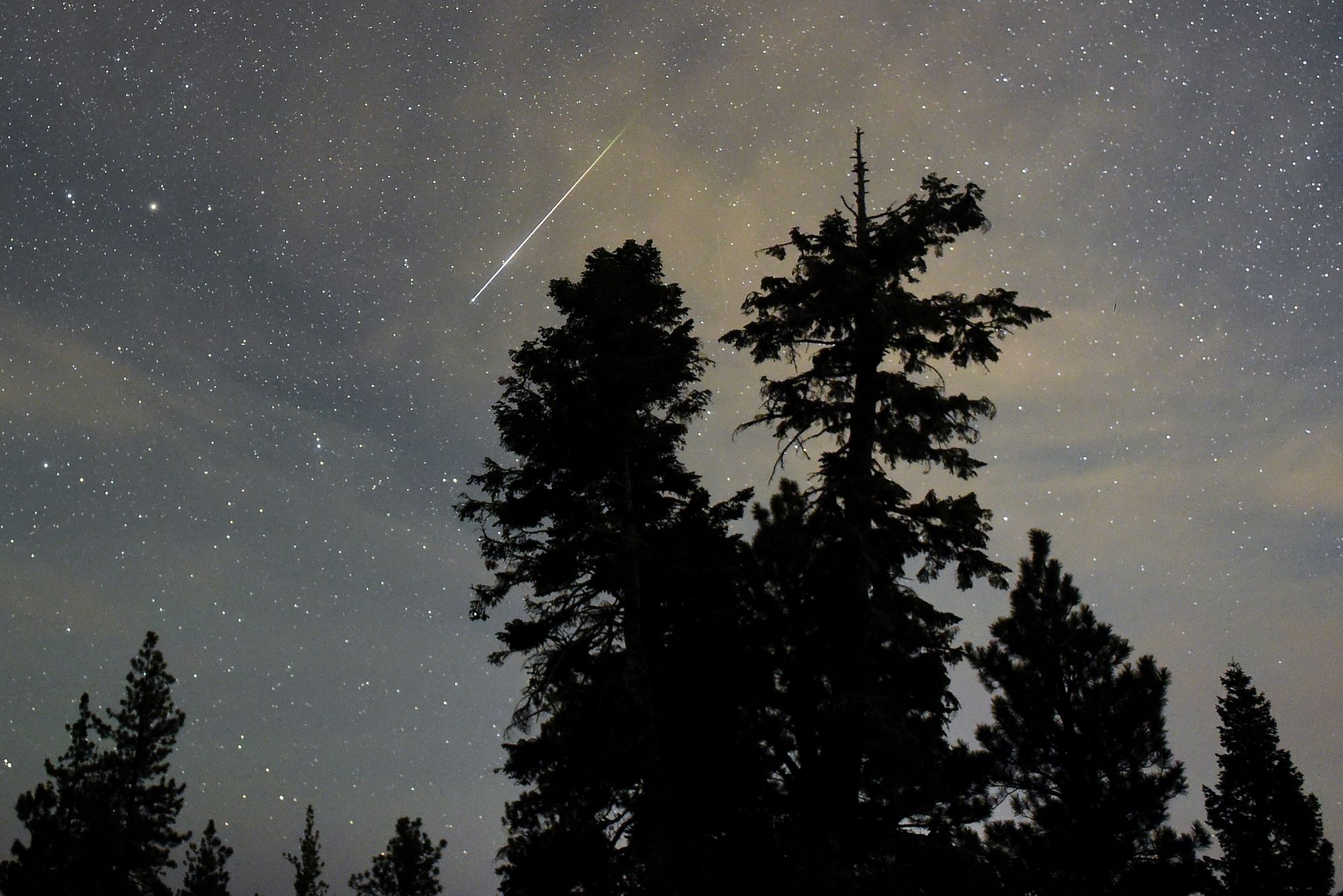 A Perseid meteor streaks across the sky on August 13, 2015 in the Spring Mountains National Recreation Area, Nevada. The annual display, known as the Perseid shower because the meteors appear to radiate from the constellation Perseus in the northeastern sky, is a result of Earth's orbit passing through debris from the comet Swift-Tuttle.