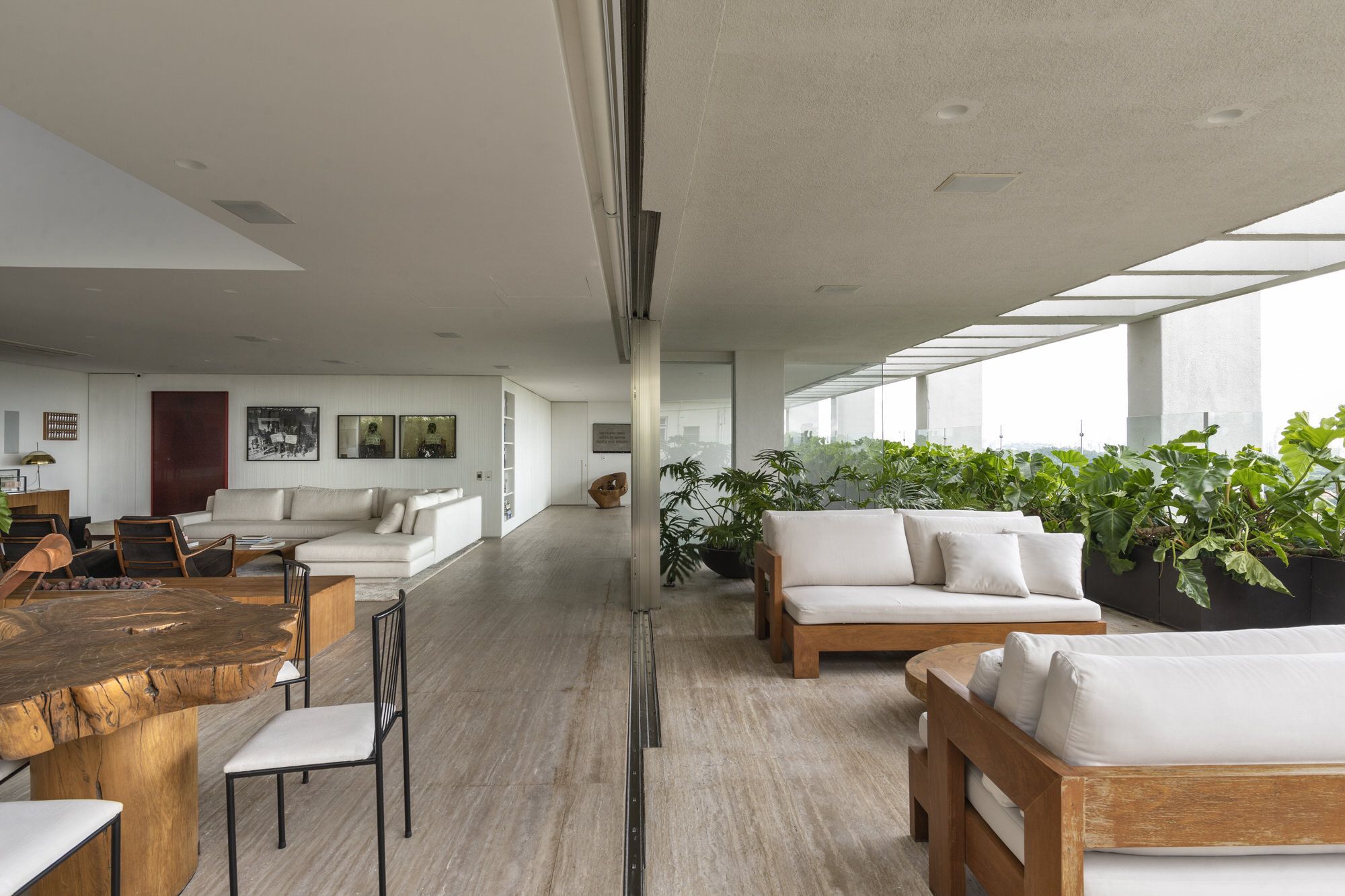 Glass doors sliding through iron frames connect both spaces