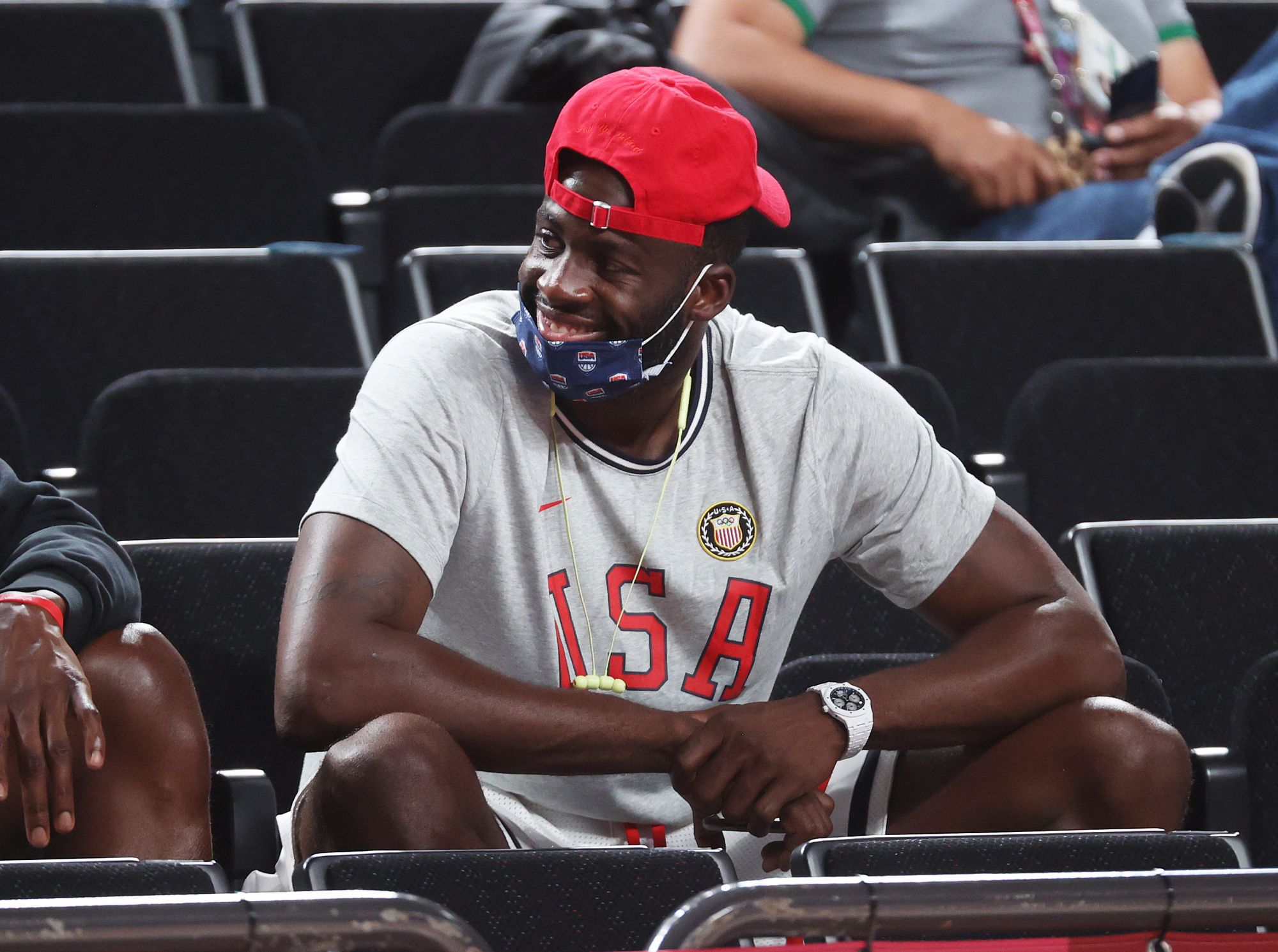 SAITAMA, JAPAN - AUGUST 06: Draymond Green watches the United States Women's Basketball team play Team Serbia during the first half of a Women's Basketball Semifinals game on day fourteen of the Tokyo 2020 Olympic Games at Saitama Super Arena on August 06, 2021 in Saitama, Japan. (Photo by Gregory Shamus/Getty Images)