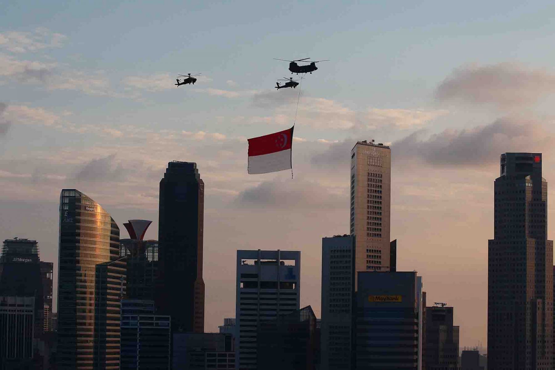 The CH-47 Chinook helicopter, escorted by two AH-64D Apache helicopters make a flypast of the State Flag during the National Day Parade. (Photo: Getty Images)