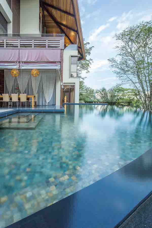 The living area leads to a swimming pool whose arc design renders it spectacular