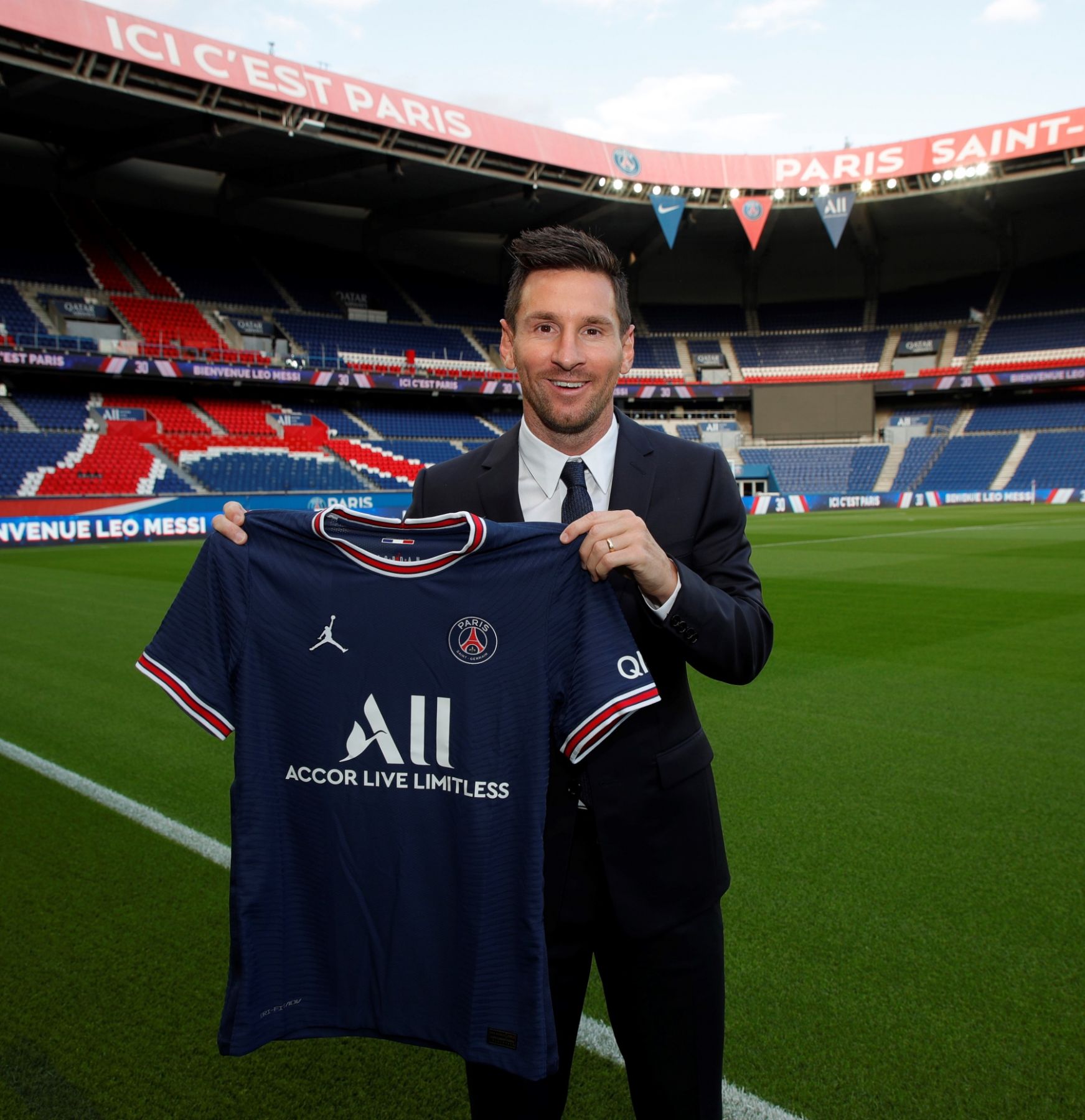 PARIS, FRANCE - AUGUST 10: Lionel Messi poses with the Paris Saint-Germain jersey after signing a 2 year contract at Parc des Princes on August 10, 2021 in Paris, France. (Photo by Paris Saint-Germain Football/PSG via Getty Images)